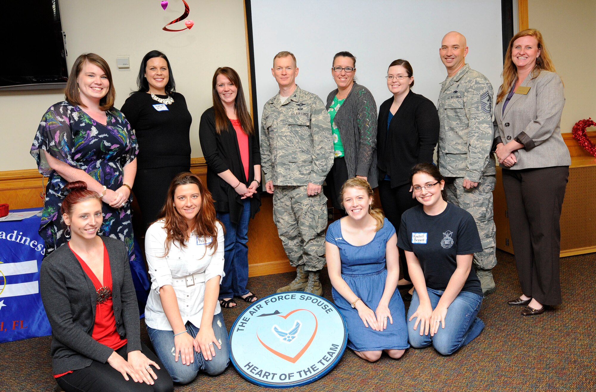 Col. William West, 1st Special Operations Wing commander, and Chief Master Sgt. Jeffery Maberry, 1st SOW command chief, pose with spouses during Heartlink at the airman & family readiness center on Hurlburt Field, Fla., Feb. 24, 2014. Spouses, who were new to the base, learned about special operations during this class with presentations, activities and a tour of the Deployment Control Center. (U.S. Air Force photo/Airman 1st Class Andrea Posey)