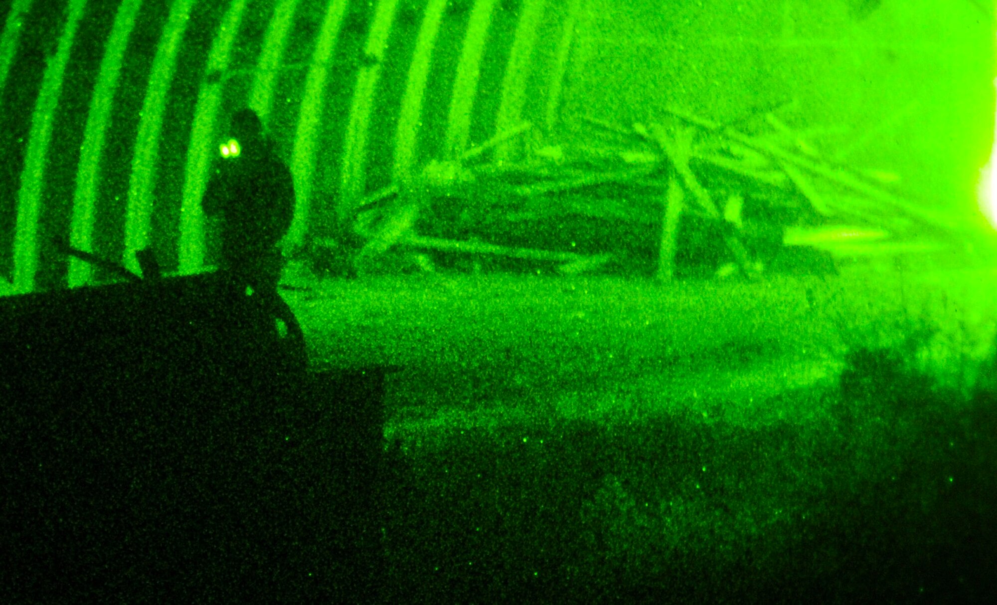 An opposing forces member patrols a hardened aircraft shelter during a night exercise on Eglin Range, Fla., Feb. 20, 2014. Opposing forces members simulated resistance for the ground forces to provide realistic training. (U.S. Air Force photo/Senior Airman Michelle Vickers)