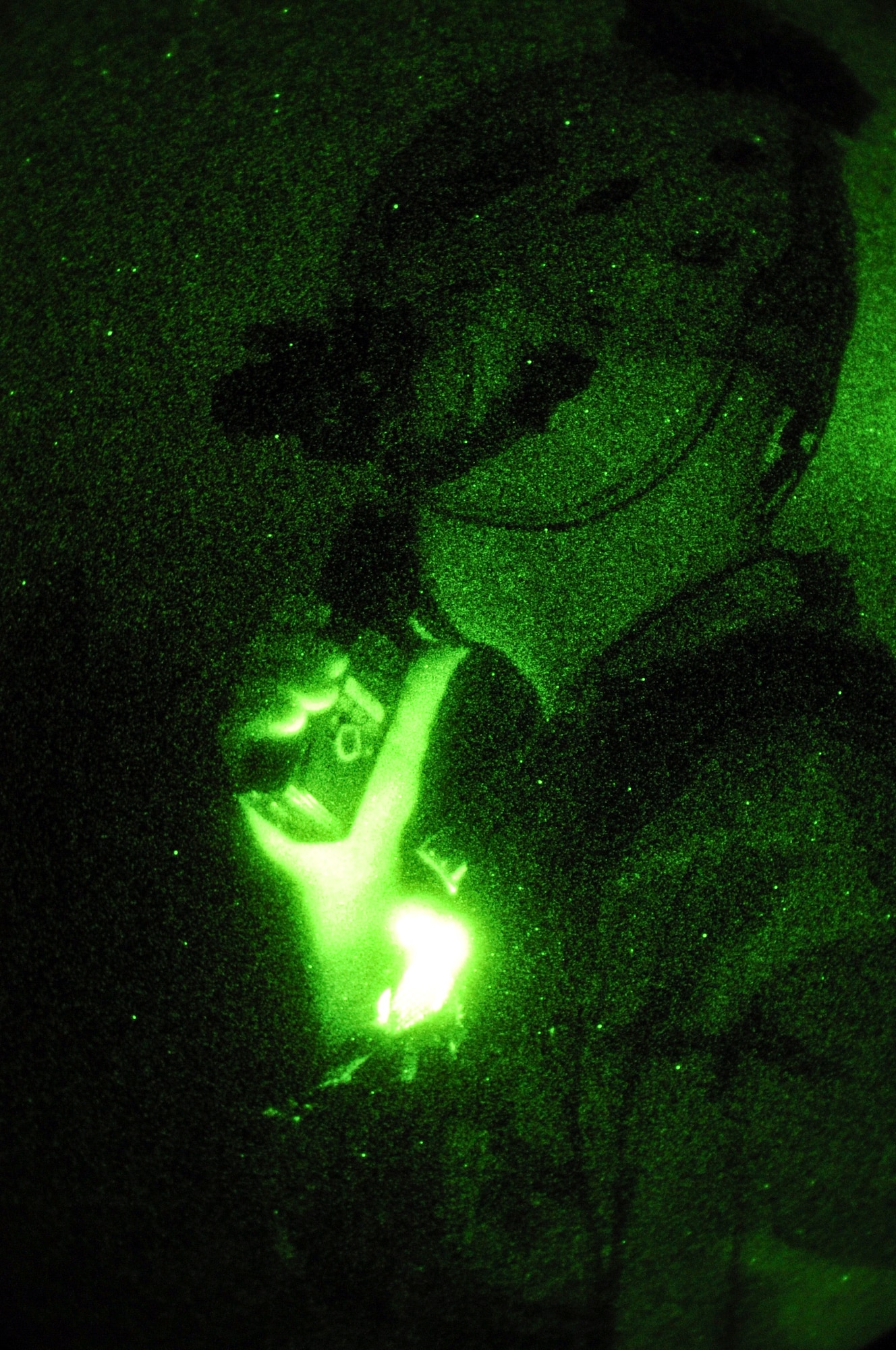 Maj. Kenneth Moerscher, 1st Special Operations Group special technical operations chief, speaks over a radio during a night exercise on Eglin Range, Fla., Feb. 20, 2014. Moerscher coordinated the joint exercise between Hurlburt Field assets and the Army’s 7th Special Forces Group. (U.S. Air Force photo/Senior Airman Michelle Vickers) 