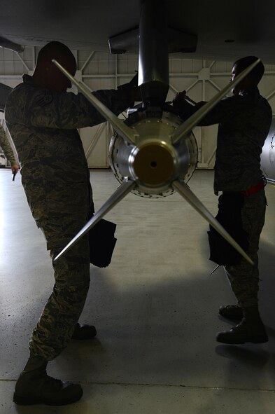 U.S. Air Force Staff Sgt. Kevin Pittman and Airman 1st Class Chris Wilfong, both 77th Fighter Squadron load crew members, load a GBU-31 joint direct attack munition onto an F-16 Fighting Falcon, Shaw Air Force Base, S.C., Feb. 21, 2014. The two, along with Senior Airman Tyler Daugherty, also loaded an AIM-9 missile while competing for the title of load crew of the quarter. (U.S. Air Force photo by Airman 1st Class Jensen Stidham/Released) 
