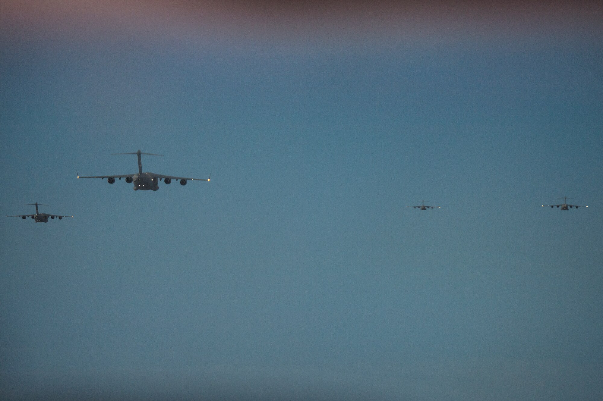 U.S. Air Force C-17 Globemaster III aircraft fly in formation as they head for Lopburi, Thailand for Operation Cobra Gold 2014, Jan. 14, 2014. During the 18-hour flight from Joint Base Elmendorf-Richardson, the five-ship C-17 formation performed two air refueling operations with KC-135 Stratotankers. (U.S. Air Force photo by Senior Airman James Richardson)