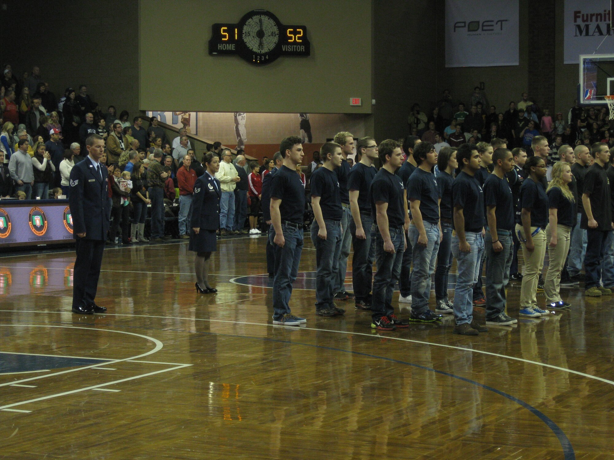 Thirty Air Force Delayed Entry Program members take the oath of enlistment during half-time at a Sioux Falls Skyforce basketball game in Sioux Falls, S.D., Jan. 17. Staff Sgt. Bobbie Guthrie and Staff Sgt. Brady Techen, 343rd Recruiting Squadron recruiters, stand at attention behind the DEP formation. The Skyforce hosted a military appreciation night that attracted 3,393 fans as the Skyforce defeated the Delaware 87ers, 100-93. (U.S. Air Force photo/Airman 1st Class Lane Rabern)

