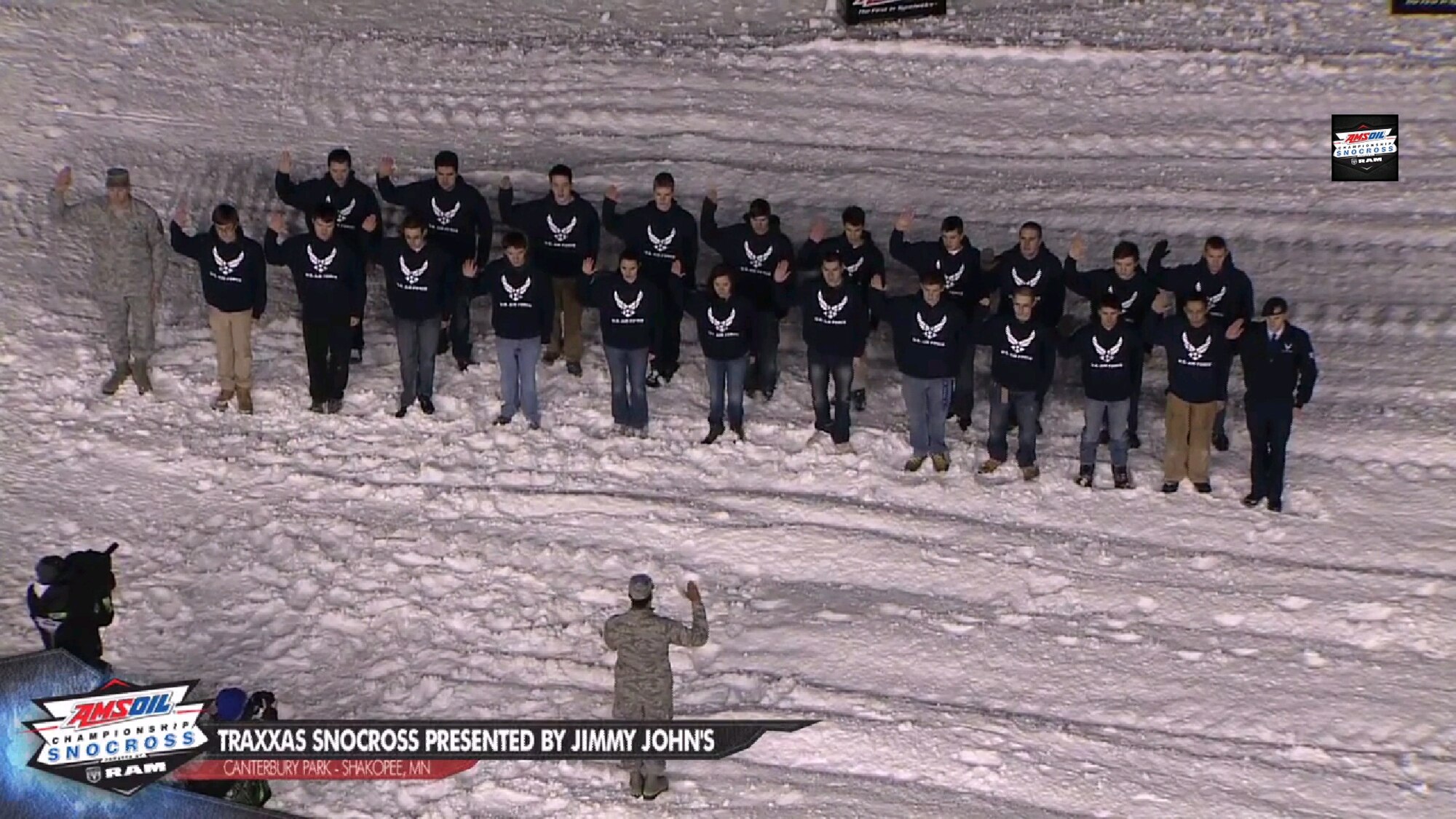 Capt. Rudolph Bowen, 343rd Recruiting Squadron Operations Flight commander, administers the oath of enlistment to 21 members of the Delayed Entry Program at Canterbury Park's Traxxas Snocross in Shakopee, Minn., Jan. 4.  The event attracted more than 12,000 people who cheered on the Air Force-sponsored Scheuring Speed Sports snocross racing team. More than 260,000 snocross fans viewed the race online. (Courtesy photo)