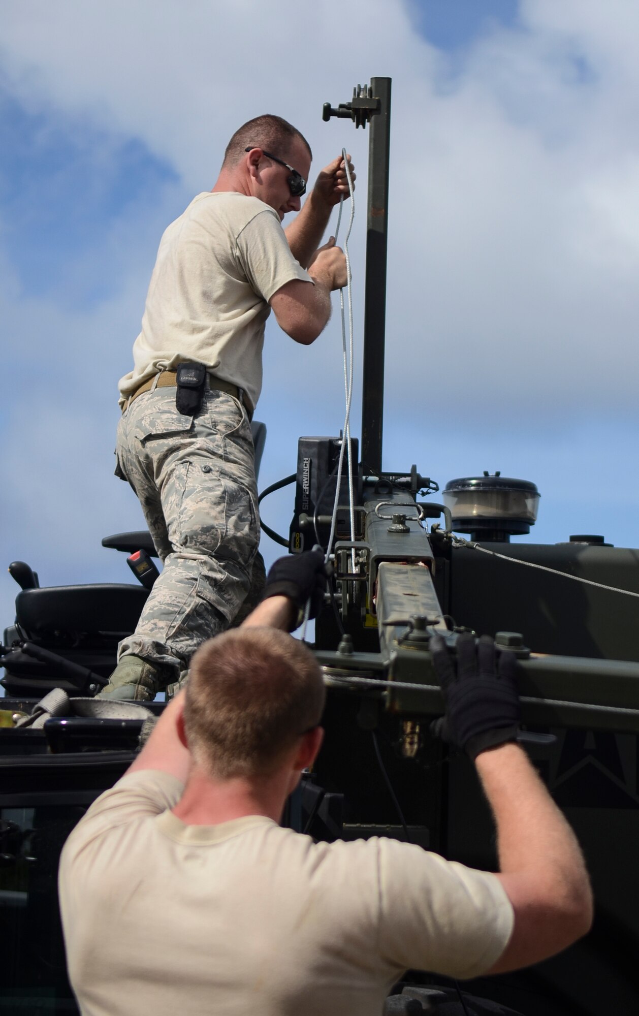 Airmen from the 36th Mobility Response Group reassemble a forklift in order to offload pallets of food from a JASDF C-130 Hercules at the Rota International Airport, for a humanitarian aid mission Feb. 19, 2014. Airmen from the U.S. Air Force, Japan Air Self-Defense Force and Royal Australian Air Force participating in Cope North, a multi-lateral exercise on Andersen Air Force Base, Guam, transitioned from the scenario-based humanitarian assistance and disaster relief training of the exercise on Tinian to humanitarian assistance of food and commodities to the citizens of Rota when Governor Eloy Inos declared Rota under a state of emergency following months without their regular resupply by sea. (U.S. Air Force photo by Senior Airman Marianique Santos/Released)