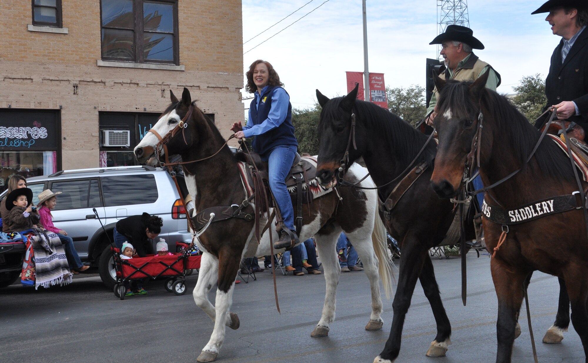 SAN ANGELO, Texas- Col. Kimberlee Joos (left), 17th Training Wing Commander, rides a horse in the 82nd Annual San Angelo Stock Show and Rodeo Parade here Feb. 22. Joos participated in the San Angelo tradition featuring floats, wagons, horses, marching bands and more from local businesses, programs and schools. The parade route traveled through downtown San Angelo. (U.S. Air Force photo/ Airman 1st Class Erica Rodriguez) 