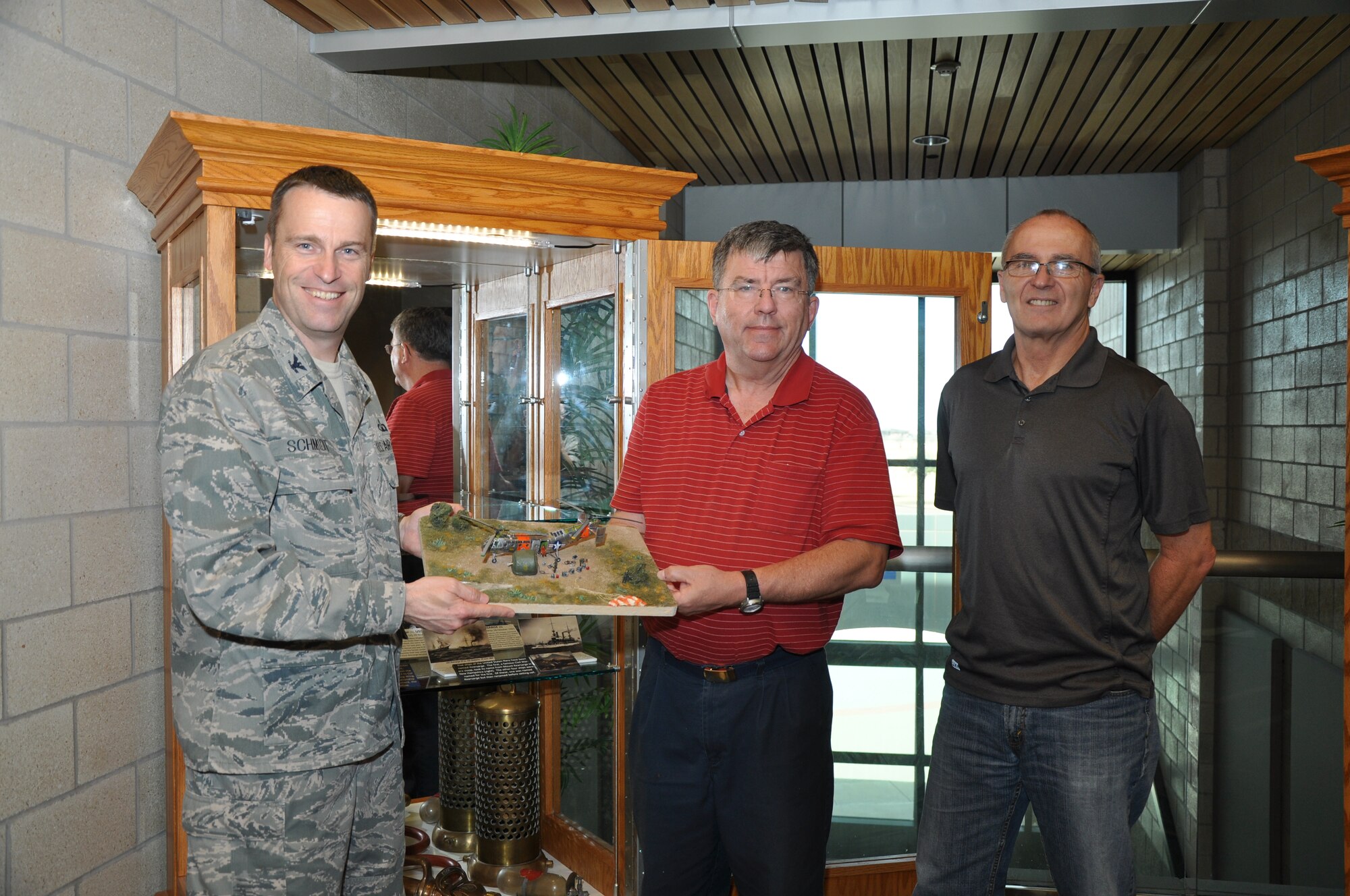 GOODFELLOW AIR FORCE BASE, Texas- Col. Thomas Schmidt, 17th Training Wing Vice Commander, receives a model of the Vertol H-21B Work Horse from Marc Stevens, San Angelo Model Club member, at the Norma Brown Building here Feb. 21. The model displays a detailed recreation of the H-21B assigned to the 1110th Balloon Activities Group Detachment 160 assigned here in the early 1960s. (U.S. Air Force photo/ Airman 1st Class Erica Rodriguez) 