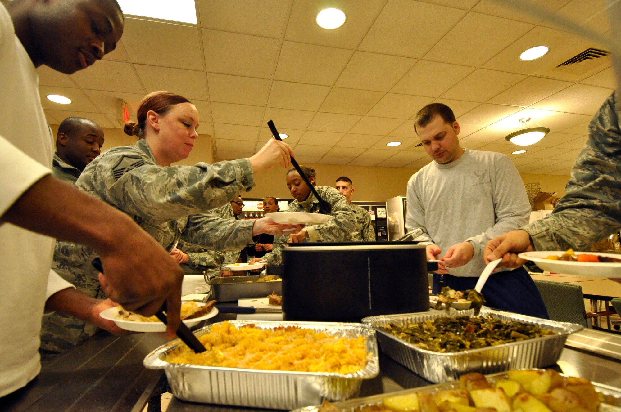 Airmen assigned to Air Force Mortuary Affairs Operations enjoy a southern home-cooked meal prepared by the deployed Religious Support Team, Feb. 19, 2014, Dover Air Force Base, Del. AFMAO has an active resiliency program for the well-being of the deployed service members assigned in support of the mortuary mission. (U.S. Air Force photo /Tech. Sgt. Shane Heiser)