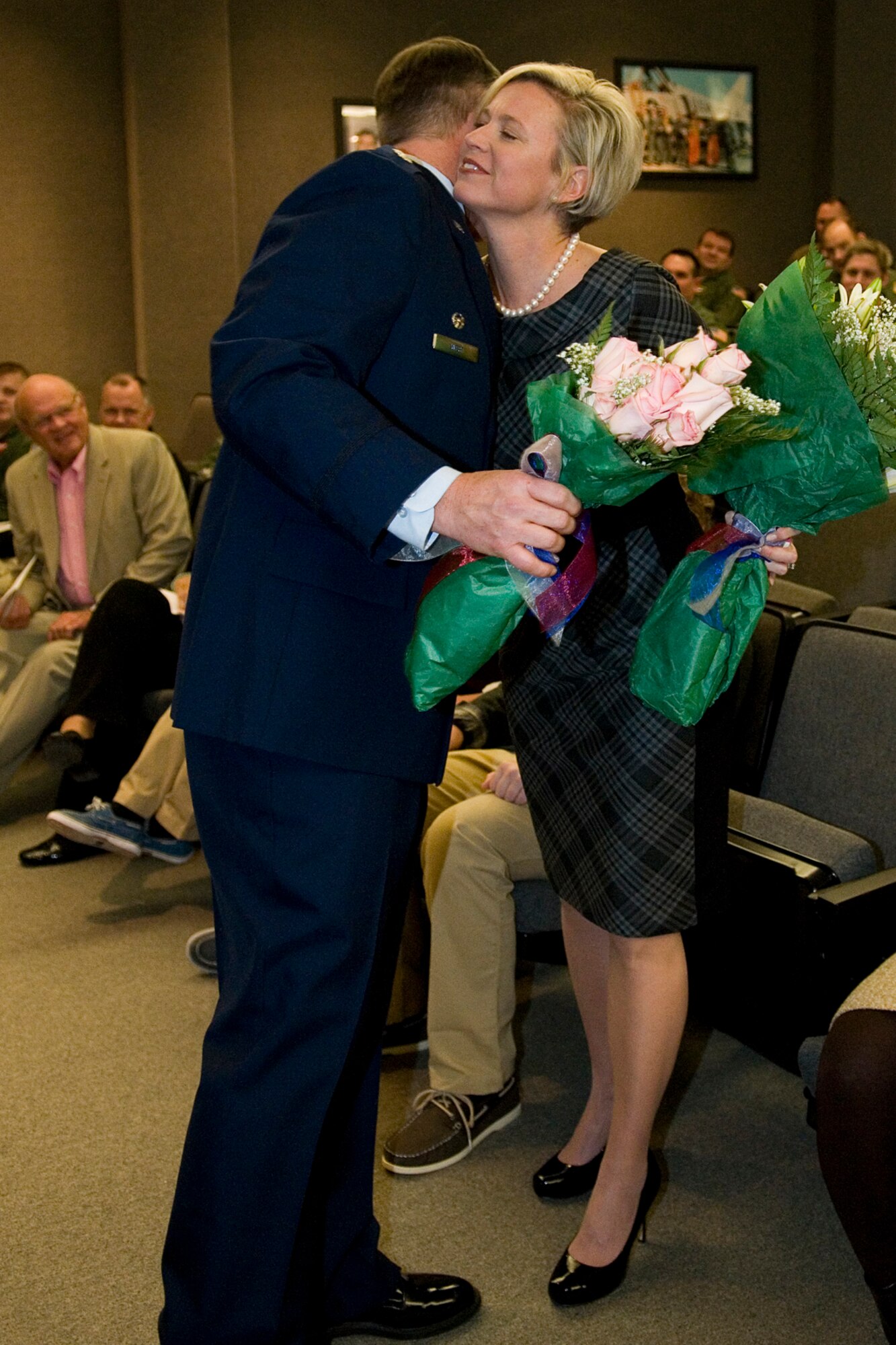 Lt. Col. James West, 74th Air Refueling Squadron commander, hugs his wife, Tracy, at a change of command ceremony at Grissom Air Reserve Base, Ind., Feb. 8, 2014. West was given command of the 74th ARS during the ceremony. (U.S. Air Force photo/Staff Sgt. Andrew McLaughlin)