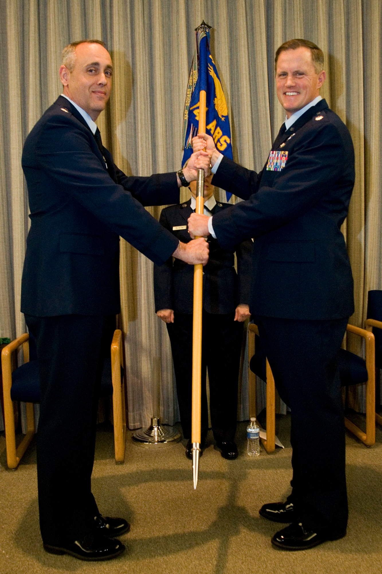 Lt. Col. James West, 74th Air Refueling Squadron commander, receives the 74th ARS guidon from Lt. Col. Gerard Malloy, 434th Operations Group commander, during a ceremony at Grissom Air Reserve Base, Ind., Feb. 8, 2014. West replaced Lt. Col. Brian Stopher as the unit commander. (U.S. Air Force photo/Staff Sgt. Andrew McLaughlin)