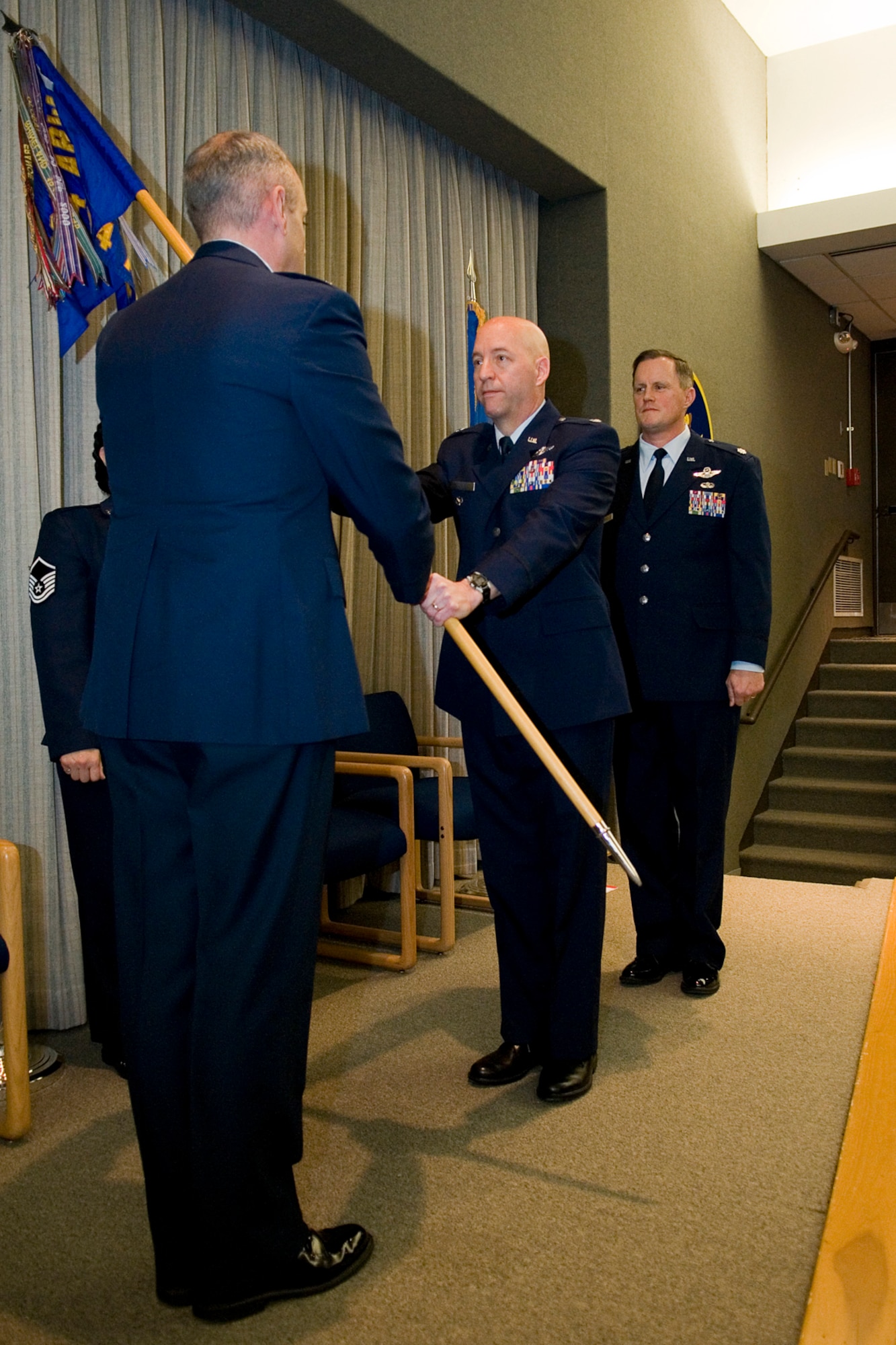 Lt. Col. Brian Stopher, former 74th Air Refueling Squadron commander, relinquishes the 74th ARS guidon to Lt. Col. Gerard Malloy, 434th Operations Group commander, during a ceremony at Grissom Air Reserve Base, Ind., Feb. 8, 2014. Lt. Col. James West was given command of the 74th ARS during the ceremony. (U.S. Air Force photo/Staff Sgt. Andrew McLaughlin)