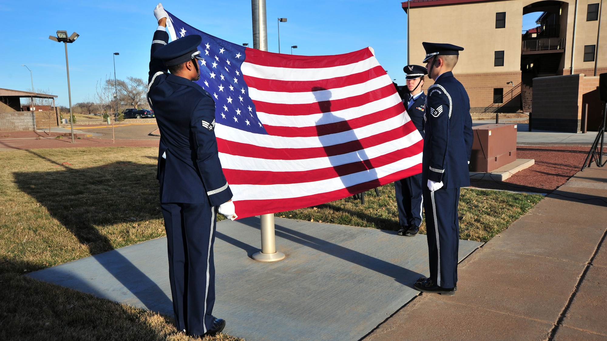 Honor guardsmen from the 27th Special Operations Wing prepare to fold the flag during a memorial ceremony Feb. 18, 2014 at Cannon Air Force Base, N.M. The ceremony was conducted in honor of Capt. Ryan Hall, Capt. Nicholas Whitlock, 1st Lt. Justin Wilkens and Senior Airman Julian Scholten, the aircrew members who lost their lives when “Ratchet 33”, a U-28A, crashed in Djibouti, Africa, Feb. 18, 2012. (U.S. Air Force photo/Senior Airman Whitney Amstutz)