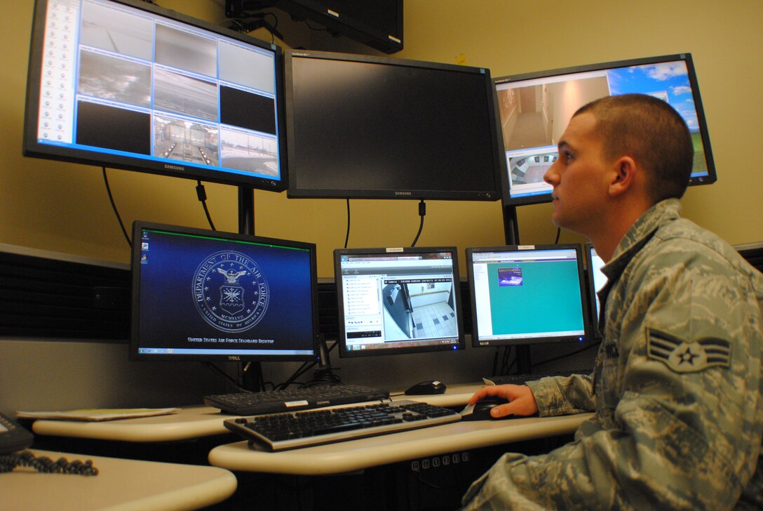 Senior Airman Tyler Burt, 319th Security Forces patrolman and alarm monitor, watches for any suspicious activity around the base from inside the Base Defense Operations Center at Grand Forks Air Force Base, N.D., on Feb. 19, 2014. Part of Burt’s daily duties is to monitor the live footage captured by various cameras set up around the base. (U.S. Air Force photo/Staff Sgt. Luis Loza Gutierrez) 