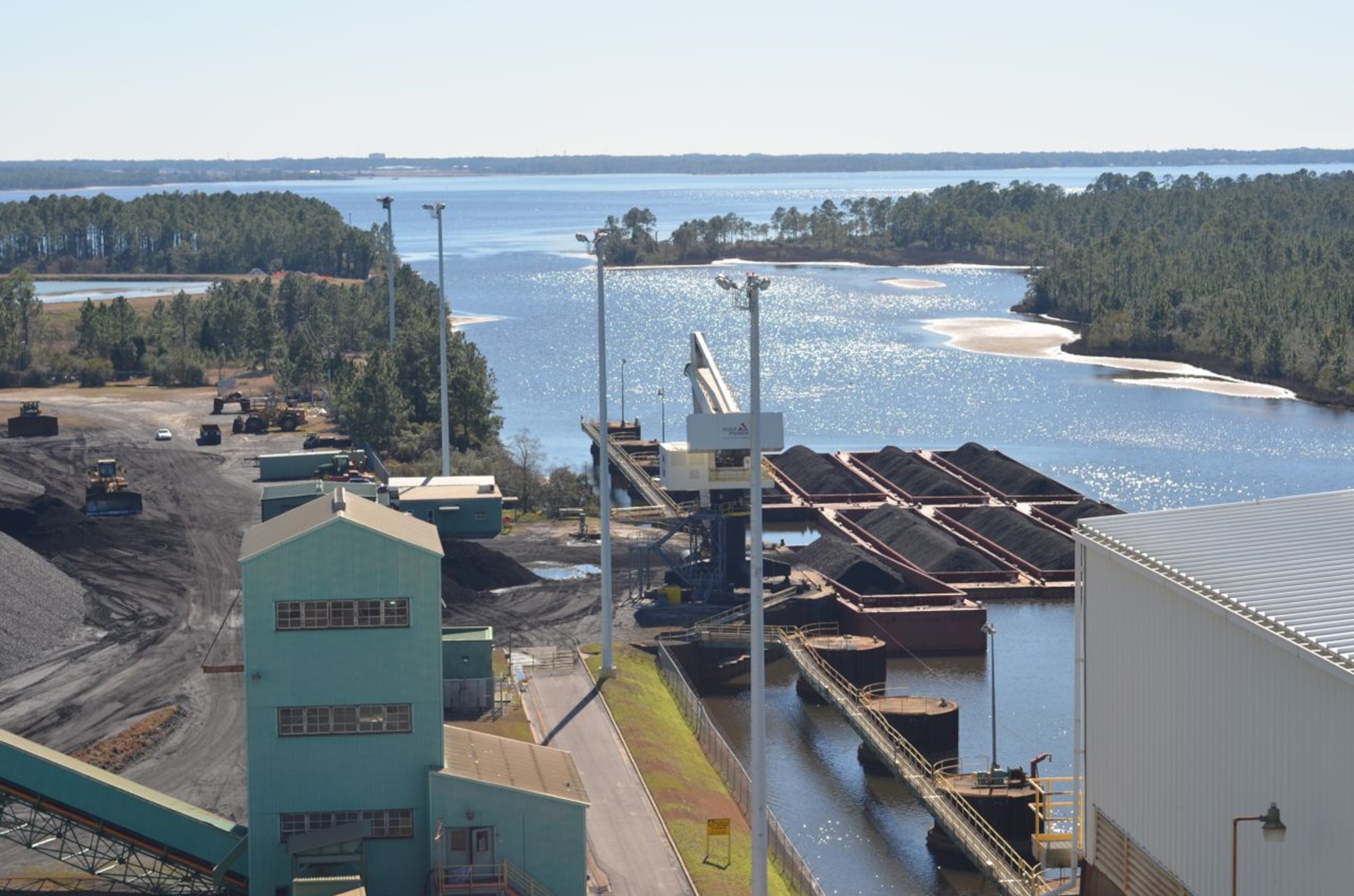 Barges deliver coal to the Lansing Smith generating plant, one of three Gulf
Power plants in the Florida panhandle. The plant has coal and natural gas
generators and a capacity of 889.9 megawatts. Among its customers are
Tyndall Air Force Base and the Naval Support Activity Panama City. Attorneys
from the Air Force Civil Engineer Center, Tyndall Detachment, Utility Law
Field Support Center, settled a rate case in late 2013 with Gulf Power and
avoided a $1.7 million increase in utility costs. (U.S. Air Force
photo/Jennifer McCabe) 
