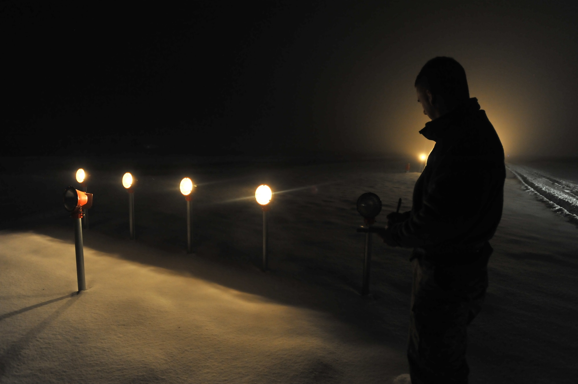 Airman 1st Class Seam Hankins, 92nd Operations Support Squadron airfield management operations coordinator, annotates a light out on the airfield inspection checklist during their nightly light checks Feb. 10, 2014, at Fairchild Air Force Base, Wash. The airfield management team conducts light checks every night to ensure all 2,168 lights are working on Fairchild’s airfield. (U.S. Air Force photo by Staff Sgt. Veronica Montes)