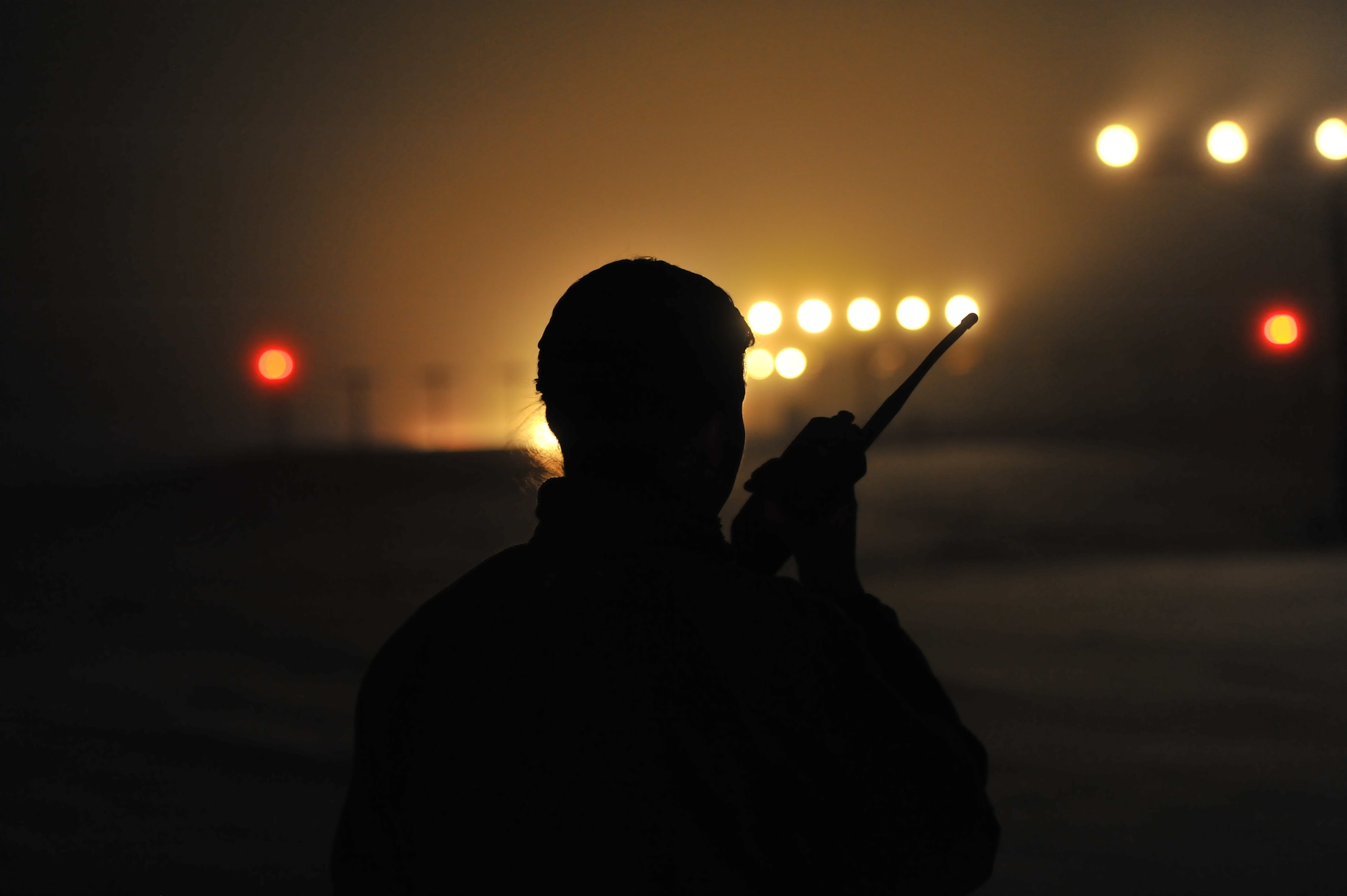 Senior Airman Alisha Laws, 92nd Operations Support Squadron airfield management shift lead, radio-calls the tower to test the approach lights on the airfield Feb. 10, 2014, at Fairchild Air Force Base, Wash. The airfield management team works 24 hours a day to ensure the airfield is safe and mission ready. (U.S. Air Force Base photo by Staff Sgt. Veronica Montes)