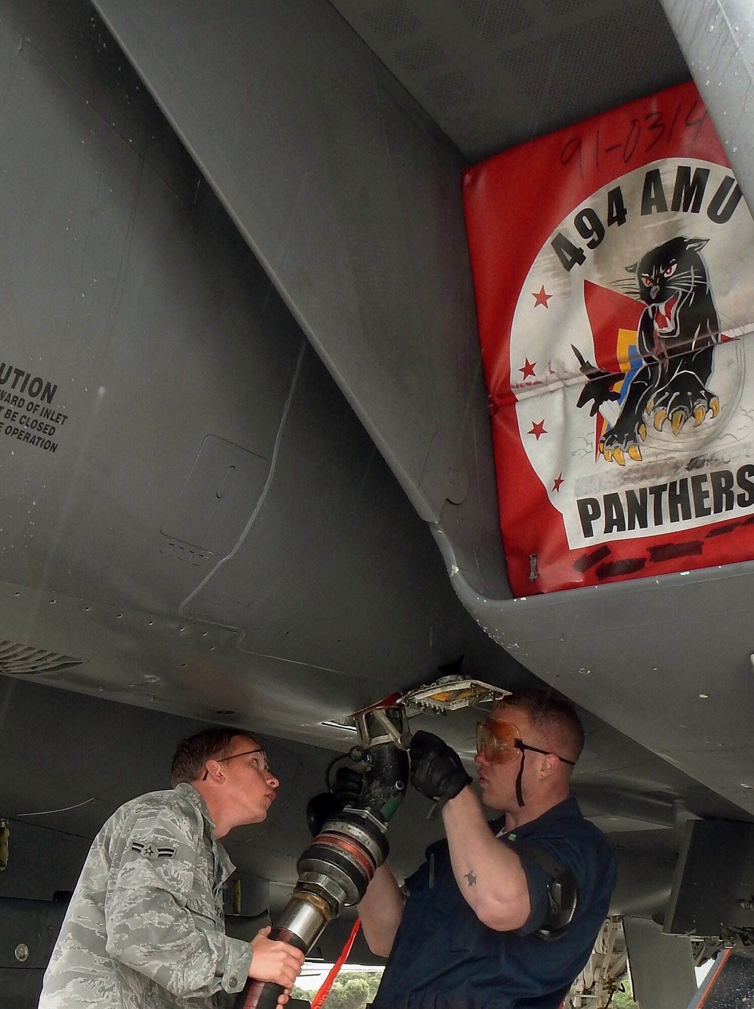 Airmen 1st Class Ray Payne, fuels apprentice, and Bryan Gwinn, F-15E Strike Eagle crew chief, both deployed to the 494th Expeditionary Fighter Squadron at Souda Bay, Greece, top off the tank of an aircraft for an upcoming mission Feb. 24, 2014. The 494th EFS was deployed by the 48th Fighter Wing at Royal Air Force Lakenheath, England, as one U.S. Air Forces in Europe unit participating in a flying training deployment to evaluate aircraft and personnel capabilities, and train in NATO operations with the Hellenic Air Force. (U.S. Air Force photo by Staff Sgt. Thomas Trower/Released)