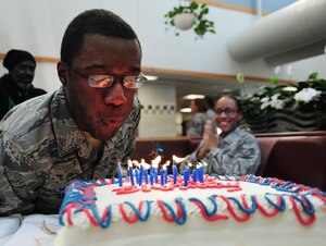 Airman 1st Class Aaron Stout blows out candles during the First Quarter Birthday meal at Freedom Hall Dining Facility, Joint Base Andrews, Md., Feb. 18. The meal celebrated the birthdays of service members grade E-6 and below that were born between the months of January to March. The meal consisted of lobster tail or fried shrimp and steak, a baked potato, corn, broccoli, side salad and cake. The event is free of charge and takes place each quarter. Stout is an 11th Wing Public Affairs photo journalist. (U.S. Air Force photo/ Airman 1st Class Joshua R.M. Dewberry)
