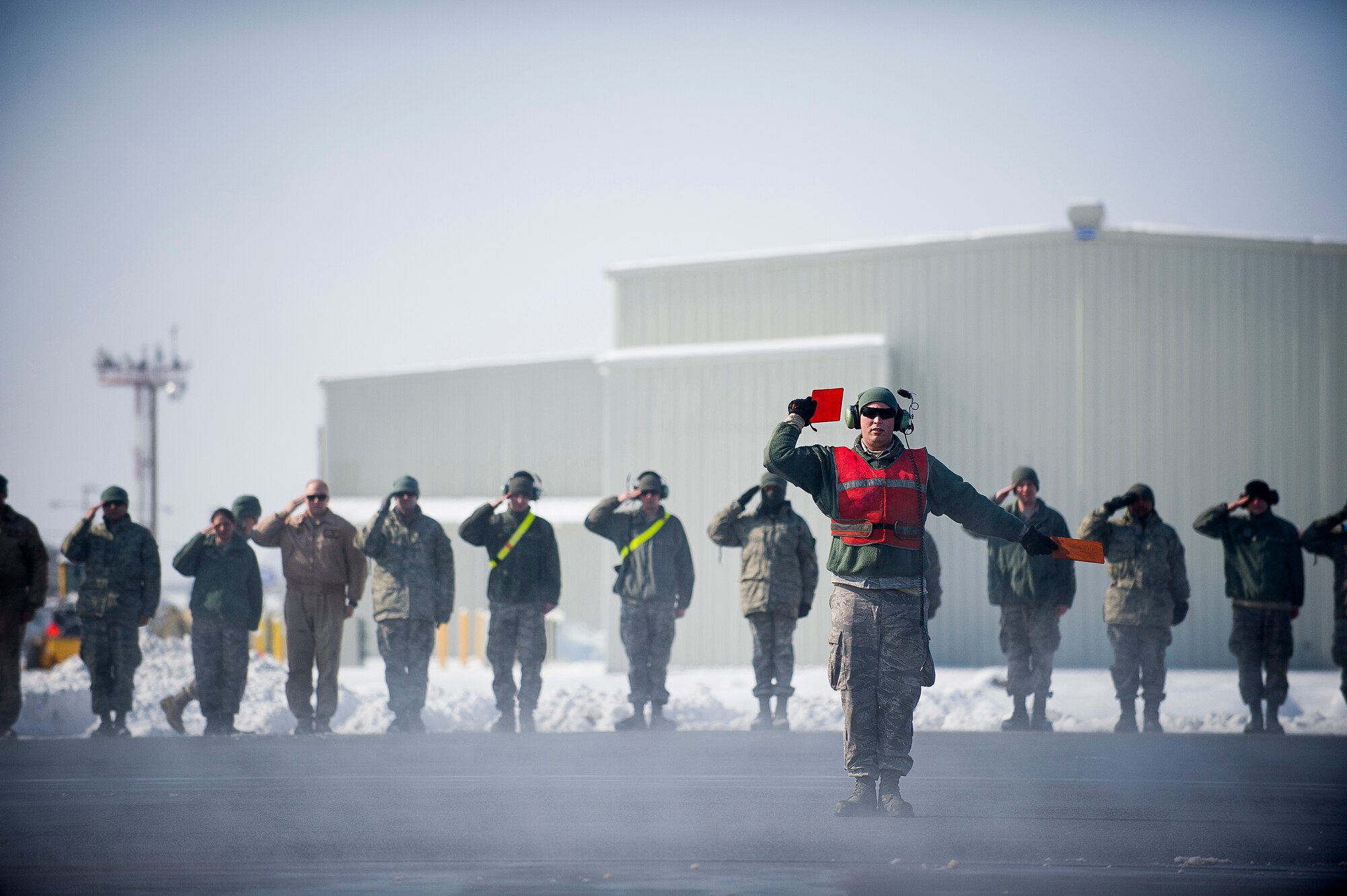 A crew chief with the 376th Expeditionary Aircraft Maintenance Squadron marshalls in a KC-135 Stratotanker after a flight at Transit Center at Manas, Kyrgyzstan, Feb. 24, 2014. The flight was the last combat refueling mission over Afghanistan from the TCM. (U.S. Air Force photo/Senior Airman George Goslin)
