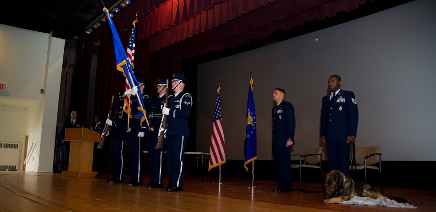 Minot Air Force Base Honor Guard presents the colors during Military Working Dog Ben retirement ceremony at Minot AFB, N.D., Feb. 19, 2013. MWD Ben left an impression on everyone who met him. Whether it was a stranger’s brief passing with him at a base event or a true friendship like that of him and his handler’s, the infamously tenacious canine will forever be remembered at Minot AFB. (U.S. Air Force photo/Senior Airman Brittany Y. Auld)               