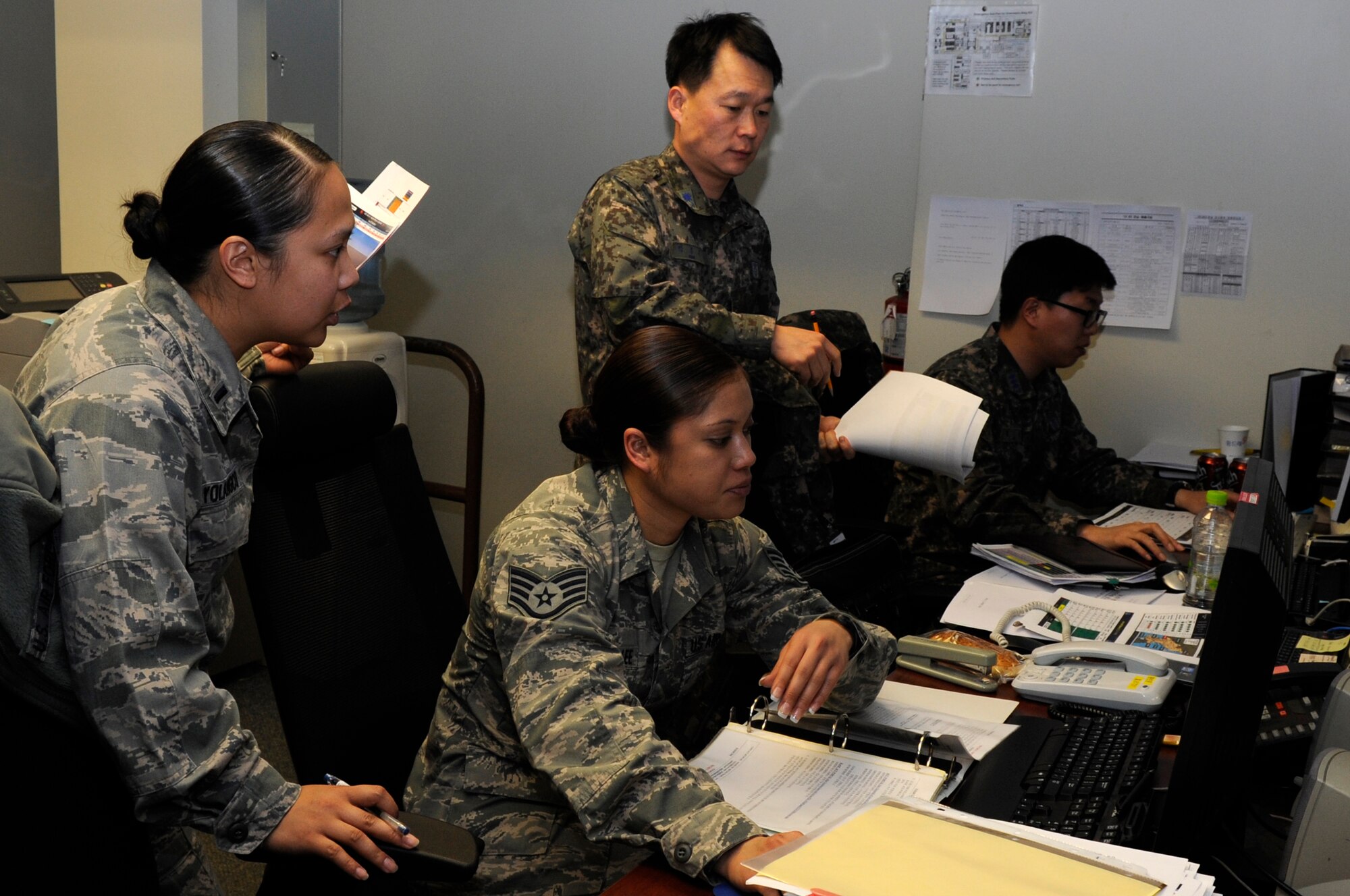 1st. Lt. Samantha Yolangco, assistant IDO from the 56th Logistics Readiness Squadron, Luke Air Force Base, Arizona and Staff Sgt. Kealakai Sumera-Lee from the 354th Mission Support, Eielson Air Force Base, Alaska, work on mission plans with their Republic of Korea counterparts during Exercise Key Resolve on Osan Air Base, Republic of Korea, Feb. 24, 2014. The exercise is designed to improve the combat readiness posture of the ROK-US Alliance and strengthen their combined operational capabilities. (U.S. Air Force photo by Senior Airman Marcus Morris)
