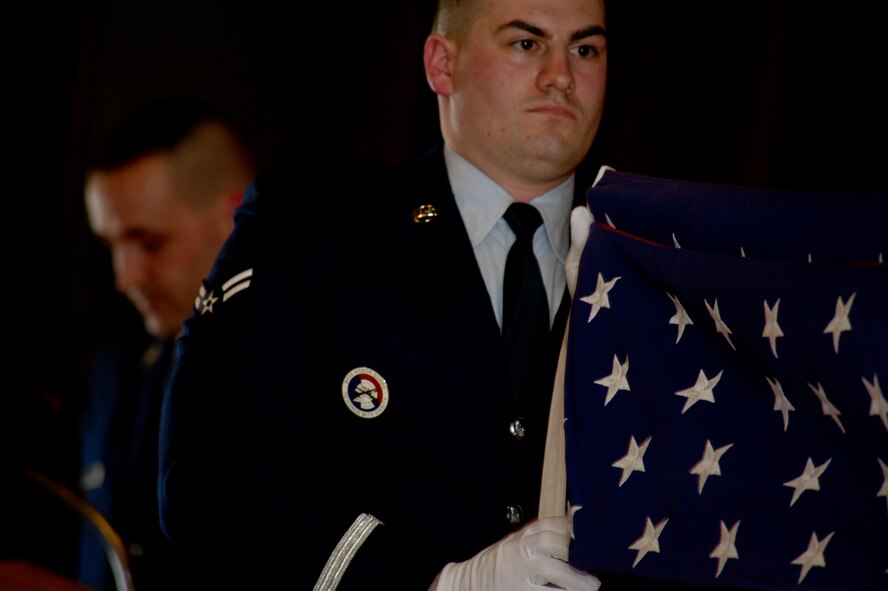 Minot Air Force Base Honor Guard performs the flag folding ceremony in honor of Military Working Dog Ben during his retirement ceremony at Minot AFB, N.D., Feb. 19, 2013. MWD Ben dedicated five-and-a-half years of duty to the United States Air Force.  (U.S. Air Force photo/Senior Airman Brittany Y. Auld)                                                       