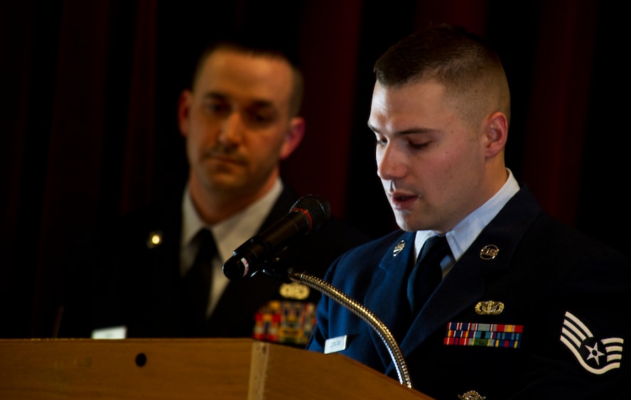 Staff Sgt. Jacob Duncan, 5th Security Forces Squadron military working dog handler recites Guardians of the Night, during Working Dog Ben’s retirement ceremony at Minot Air Force Base, N.D., Feb. 19, 2013. Ben left an impression on everyone who met him. Whether it was a stranger’s brief passing with him at a base event or a true friendship like that of him and his handler’s, the infamously tenacious canine will forever be remembered at Minot AFB.  (U.S. Air Force photo/Senior Airman Brittany Y. Auld)