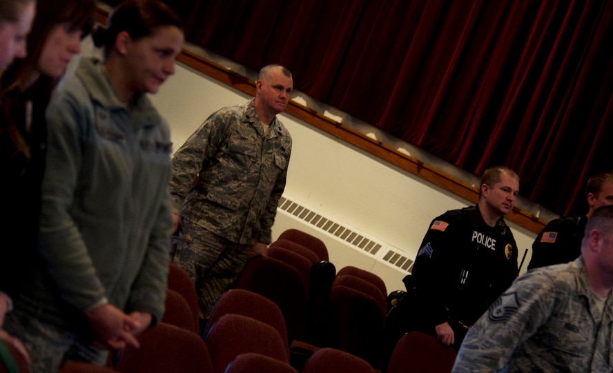 Team Minot and the local law enforcement officers stand to sing the Air Force song at the end of Military Working Dog Ben’s retirement ceremony at Minot Air Force Base, N.D., Feb. 19, 2013. MWD Ben dedicated five-and-a-half years of duty to the United States Air Force. (U.S. Air Force photo/Senior Airman Brittany Y. Auld)