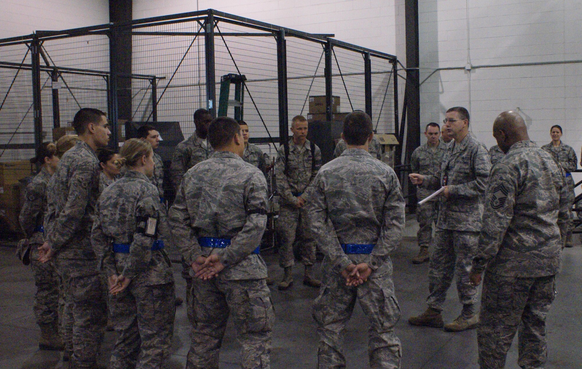 Members of 512th Airlift Wing recieve a briefing about the recent Logistics Compliance Assessment Program inspection Nov. 25. The LCAP inspection was created to function as a short-notice examination in assessing the logistics functions on an installation. (U.S. Air Force photo)
