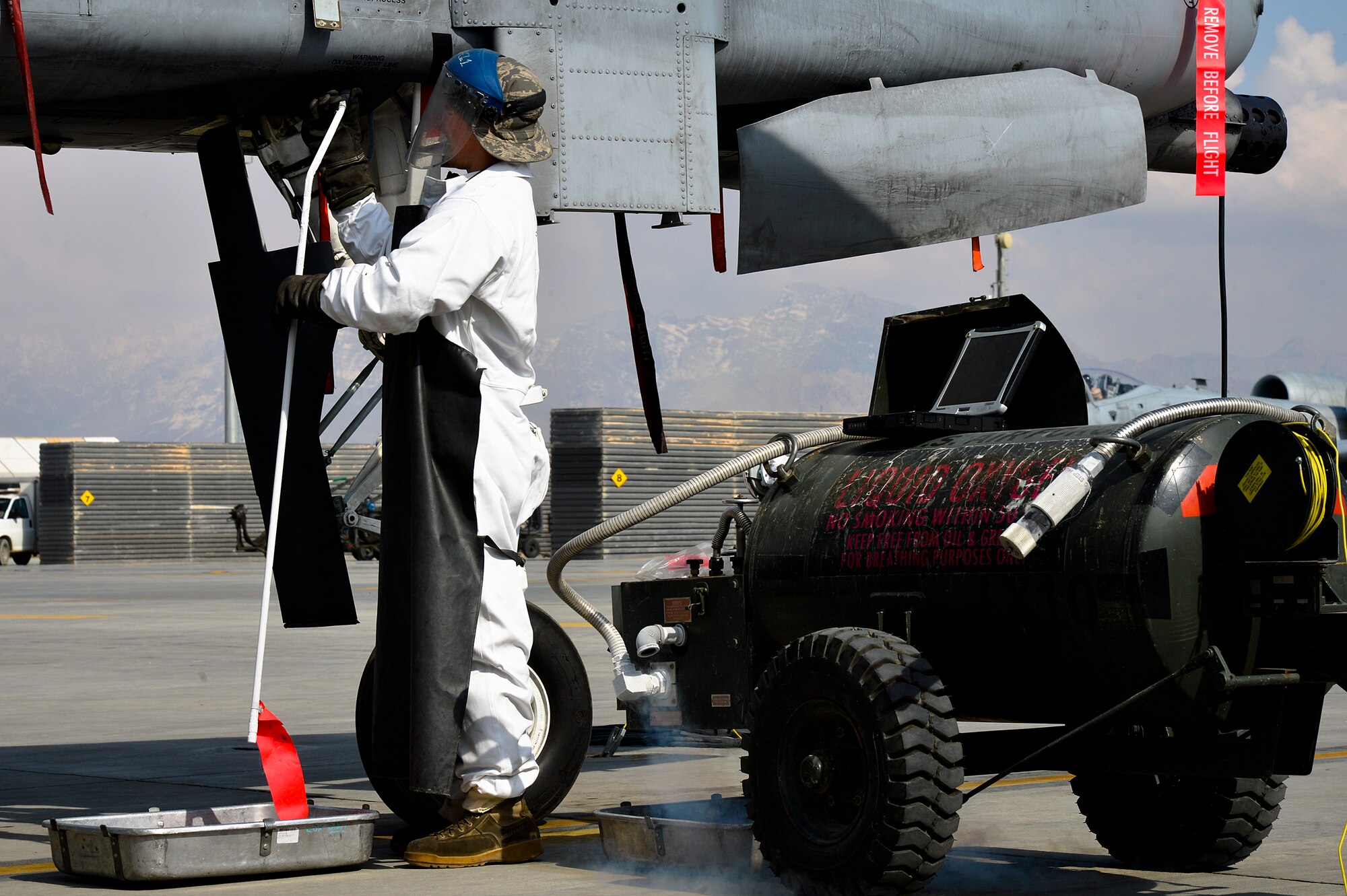 U.S. Air Force Airman 1st Class Chris Lacroix, 455th Expeditionary Aircraft Maintenance Squadron A-10 Thunderbolt II crew chief, finishes servicing an A-10 with liquid oxygen at Bagram Airfield, Afghanistan, Feb. 21, 2014. LOX is oxygen in the form of liquid until it is converted into gas and the A-10 requires 5 liters. (U.S. Air Force photo by Senior Airman Kayla Newman/Released)