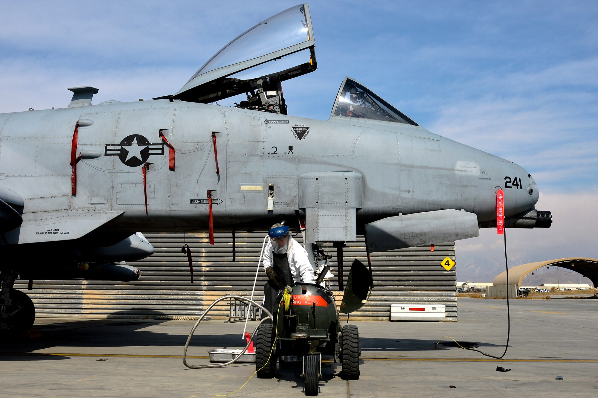 U.S. Air Force Airman 1st Class Chris Lacroix, 455th Expeditionary Aircraft Maintenance Squadron A-10 Thunderbolt II crew chief, services an A-10 with liquid oxygen at Bagram Airfield, Afghanistan, Feb. 21, 2014. LOX is oxygen in the form of liquid until it is converted into gas and the A-10 requires 5 liters. (U.S. Air Force photo by Senior Airman Kayla Newman/Released)