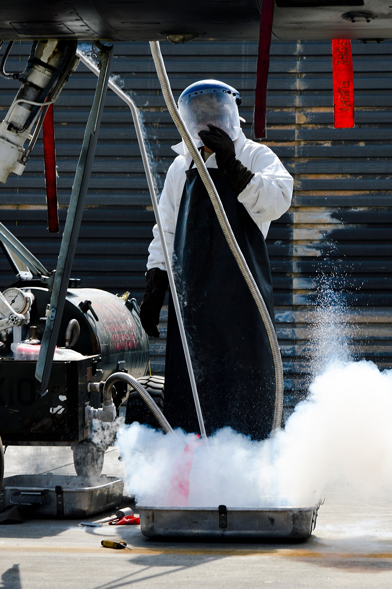 U.S. Air Force Airman 1st Class Chris Lacroix, 455th Expeditionary Aircraft Maintenance Squadron A-10 Thunderbolt II crew chief, services an A-10 with liquid oxygen at Bagram Airfield, Afghanistan, Feb. 21, 2014. LOX is oxygen in the form of liquid until it is converted into gas and the A-10 requires 5 liters. (U.S. Air Force photo by Senior Airman Kayla Newman/Released)