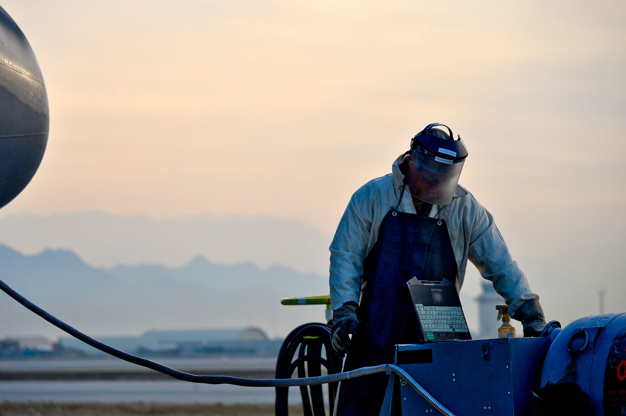 U.S. Air Force Senior Airman Matthew Martin, 455th Expeditionary Aircraft Maintenance Squadron C-130J Super Hercules crew chief, services a C-130J with liquid oxygen at Bagram Airfield, Afghanistan, Feb. 21, 2014. LOX is oxygen in the form of liquid until it is converted into gas, which allows pilots, aircrew members and everyone on board the aircraft the ability to breathe while in the air. (U.S. Air Force photo by Senior Airman Kayla Newman/Released)