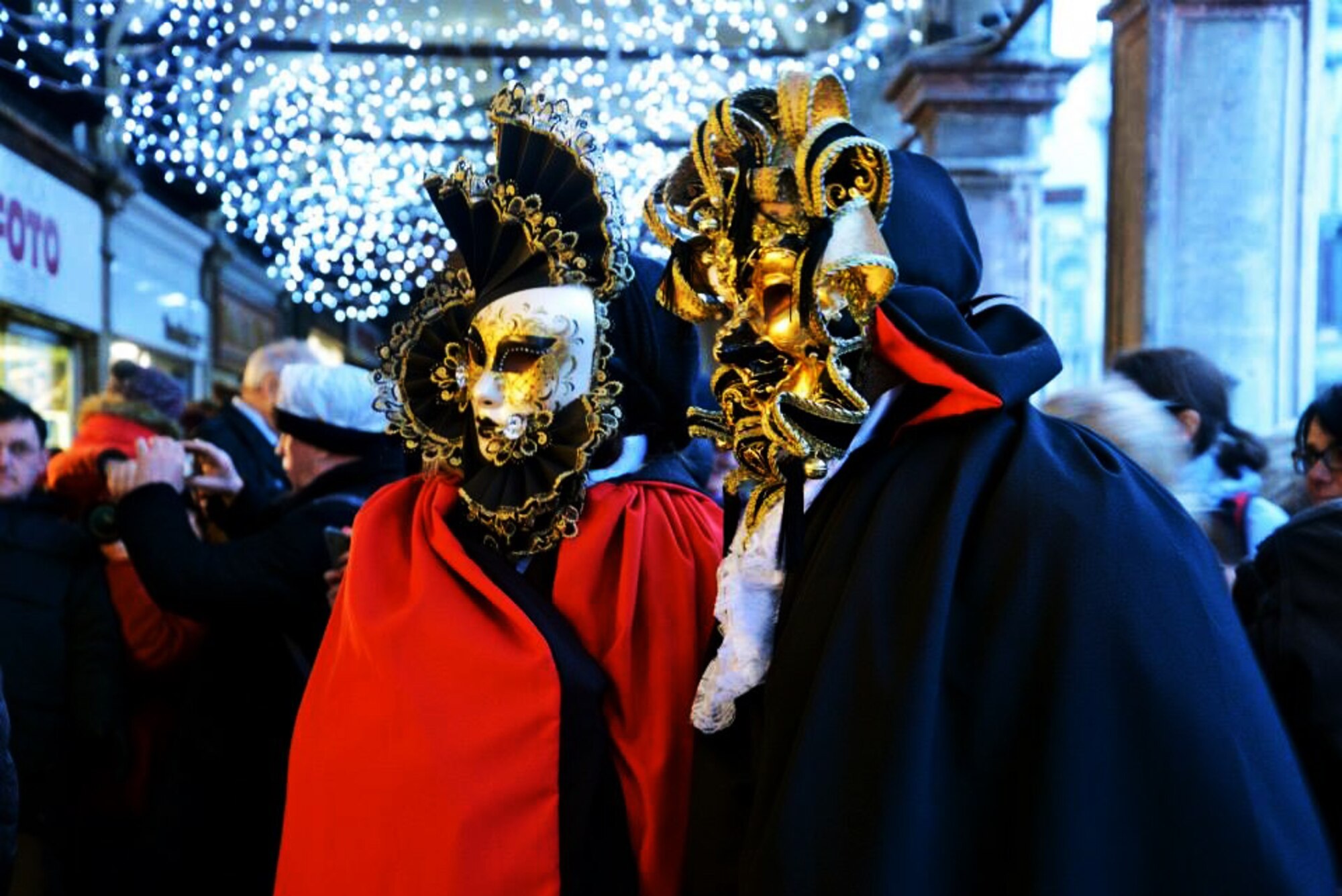 Tourists dressed in full masks and elaborate 18th-century attire pose for a photo in San Marco square during Carnevale di Venezia, an annual festival held in Venice to celebrate the days leading up to Lent. (U.S. Air Force photo/1st Lt. Lacie Collins)