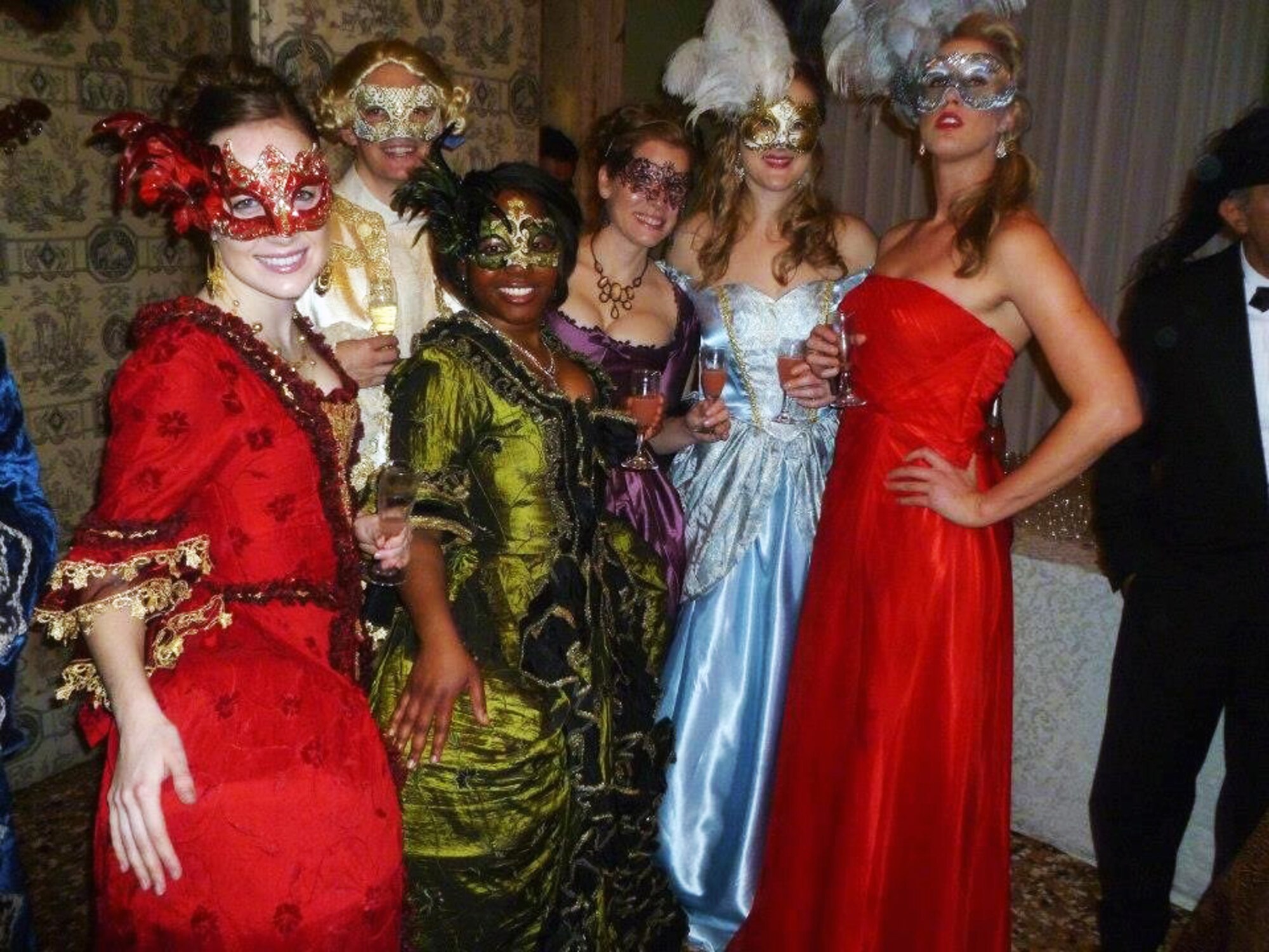 A young group of Americans dressed in 18th-century Venetian attire poses at one of the various ‘Grand Ball’ private parties during Carnevale di Venezia. Tickets for the 3-4 hour events range from around 200-500 euro and may include: dinner, dancing, a live orchestra, theatre shows, acrobat shows, and more. (U.S. Air Force photo/2nd Lt Allie Delury)