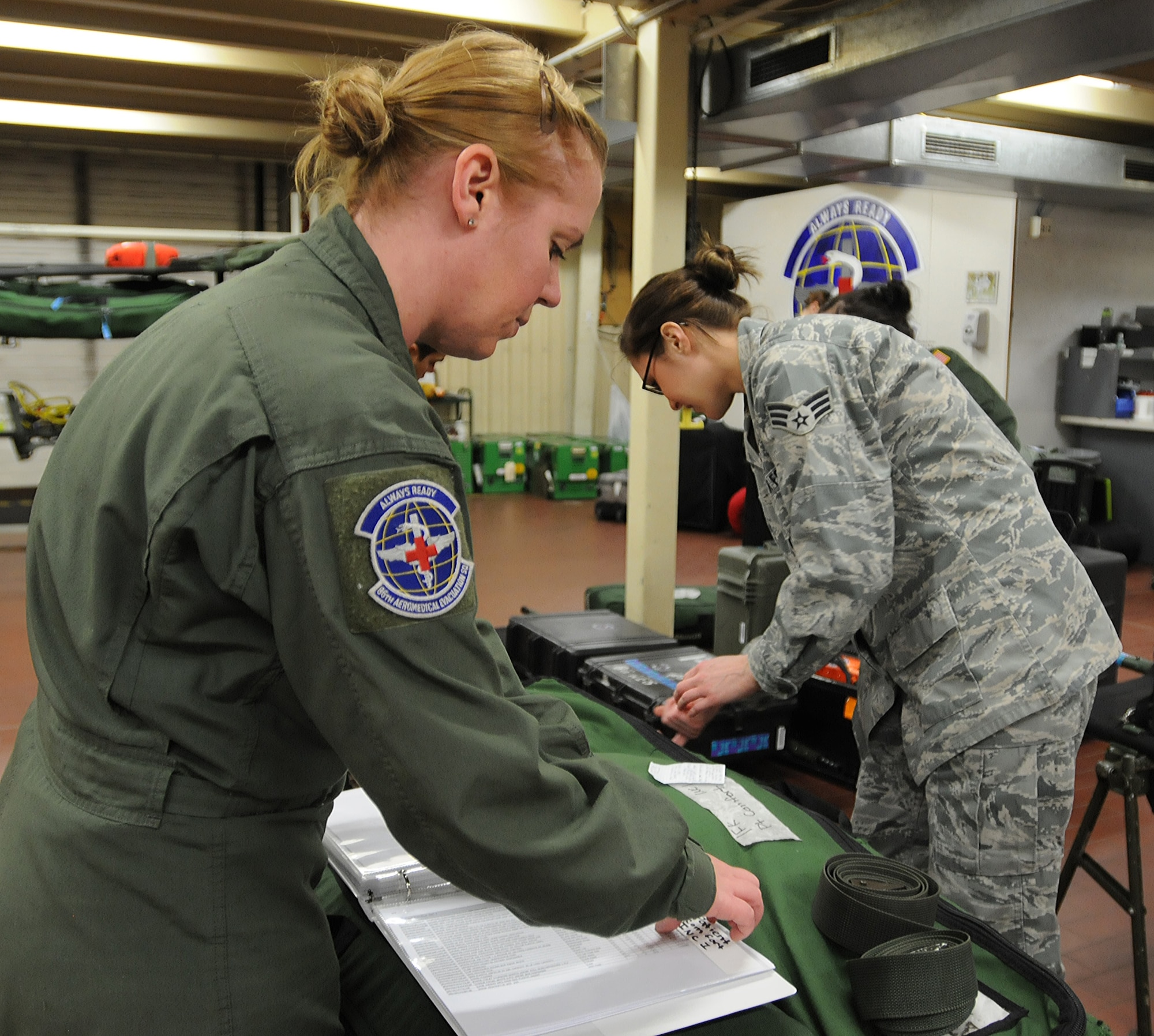 Staff Sgt. Lindsay Rhodes(left) and Senior Airman Amber Wingate, 86th Aeromedical Evacuation Squadron aeromedical evacuation technicians, take inventory of flight medical equipment used during an incoming flight Feb. 20, 2014, Ramstein Air Base, Germany. Members of the 86th AES are responsible for loading injured service members and other government personnel onto aircraft to provide medical care until arriving at a hospital.(U.S. Air Force photo/Airman 1st Class Holly Mansfield)