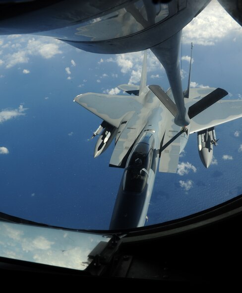 A KC-135 Stratotanker refuels an F-15 Eagle from Kadena Air Base, Japan, during an aerial refueling exercise in the Asia-Pacific region Feb. 24, 2014. The KC-135 boom is a rigid, telescoping tube capable of transferring more than 200,000 pounds of fuel to refuel U.S. and allied partner aircraft. (U.S. Air Force photo by Airman 1st Class Keith James)