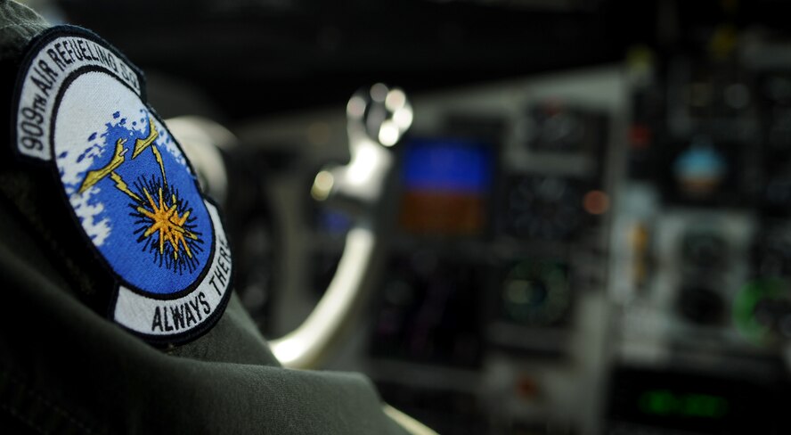 U.S. Air Force Capt. Jonah Guajardo, 909th Air Refueling Squadron pilot, displays a 909th Air Refueling Squadron patch on his flight suit while aboard a KC-135 Stratotanker from Kadena Air Base, Japan, Feb. 21, 2014. The flight was part of a refueling exercise where three F-15 Eagles and an F-22 Raptor received fuel from two KC-135 Stratotankers in the Asia-Pacific region. (U.S. Air Force photo by Airman 1st Class Keith James)
