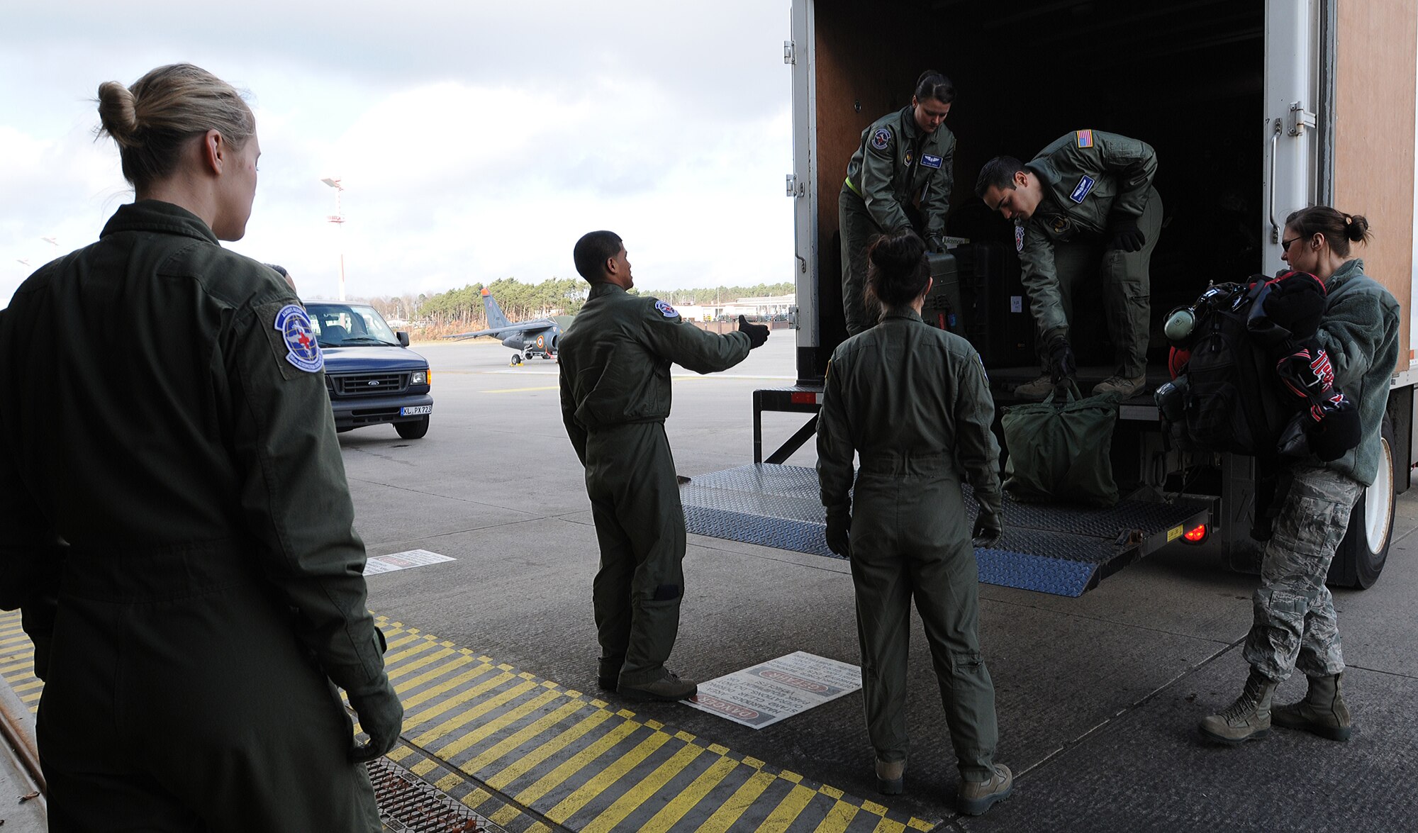 Airmen from the 86th Aeromedical Evacuation Squadron unload flight-medical equipment from an incoming flight Feb. 20, 2014, Ramstein Air Base, Germany. Members of the 86th AES are responsible for loading injured service members and other government personnel onto aircraft to provide medical care until arriving at a hospital.(U.S. Air Force photo/Airman 1st Class Holly Mansfield)