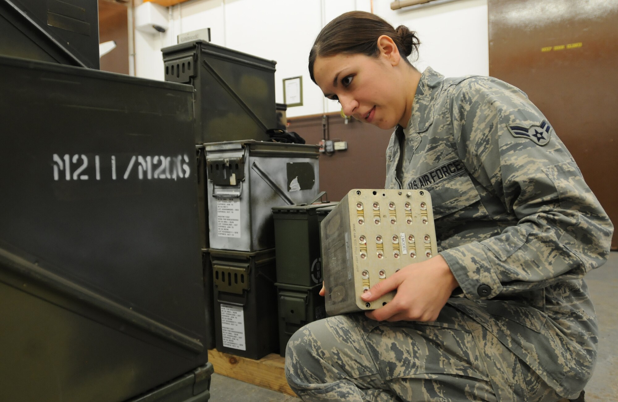 Airman 1st Class Jasmine Luce, 86th Munitions Squadron conventional maintenance crew member, makes sure numbers match up on ammunition cans to prepare for a 100 percent accountability inspection Feb. 13, 2014, Ramstein Air Base, Germany. The conventional maintenance shop is in charge of maintaining shelf and service life on countermeasures used in C-130J Super Hercules. They also perform storage monitoring inspections on in-line items kept within the munitions storage area. (U.S. Air Force photo/Airman 1st Class Holly Mansfield)