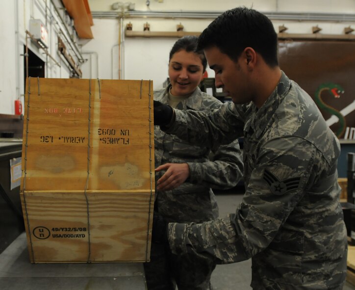 Airman 1st Class Taylor Bauman(left), 86th Munitions Squadron conventional maintenance crew member, and Senior Airman Bryan Sandt, 86th MUNS maintenance crew chief, prepare for a 100 percent accountability inspection Feb. 13, 2014, Ramstein Air Base, Germany. The conventional maintenance shop is in charge of maintaining shelf and service life on countermeasures used in C-130J Super Hercules. They also perform storage monitoring inspections on in-line items kept within the munitions storage area. (U.S. Air Force photo/Airman 1st Class Holly Mansfield)