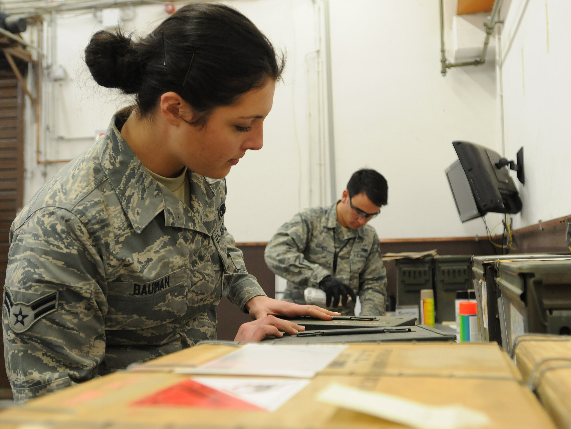 Airman 1st Class Taylor Bauman(left), 86th Munitions Squadron conventional maintenance crew member, and Senior Airman Bryan Sandt, 86th MUNS maintenance crew chief, prepare for a 100 percent accountability inspection Feb. 13, 2014, Ramstein Air Base, Germany. The conventional maintenance shop is in charge of maintaining shelf and service life on countermeasures used in C-130J Super Hercules. They also perform storage monitoring inspections on in-line items kept within the munitions storage area. (U.S. Air Force photo/Airman 1st Class Holly Mansfield)