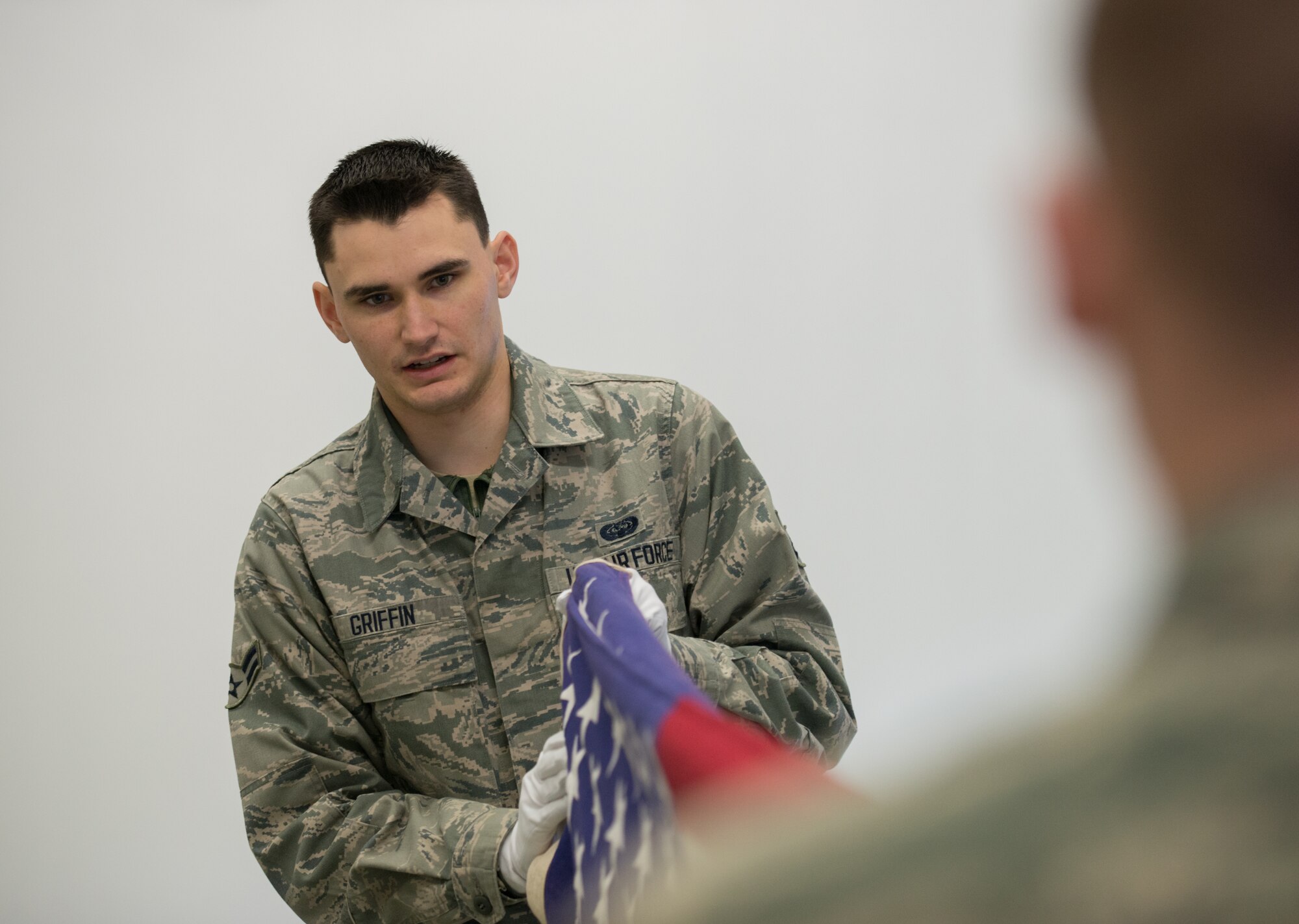 Airman 1st Class Drake Griffin, 86th Communications Squadron honor guardsman, folds an American flag during practice Feb. 19, 2014, Ramstein Air Base, Germany. Members of the base honor guard train constantly to perfect their skills and maintain readiness for ceremonies. (U.S. Air Force photo/Senior Airman Jonathan Stefanko)
