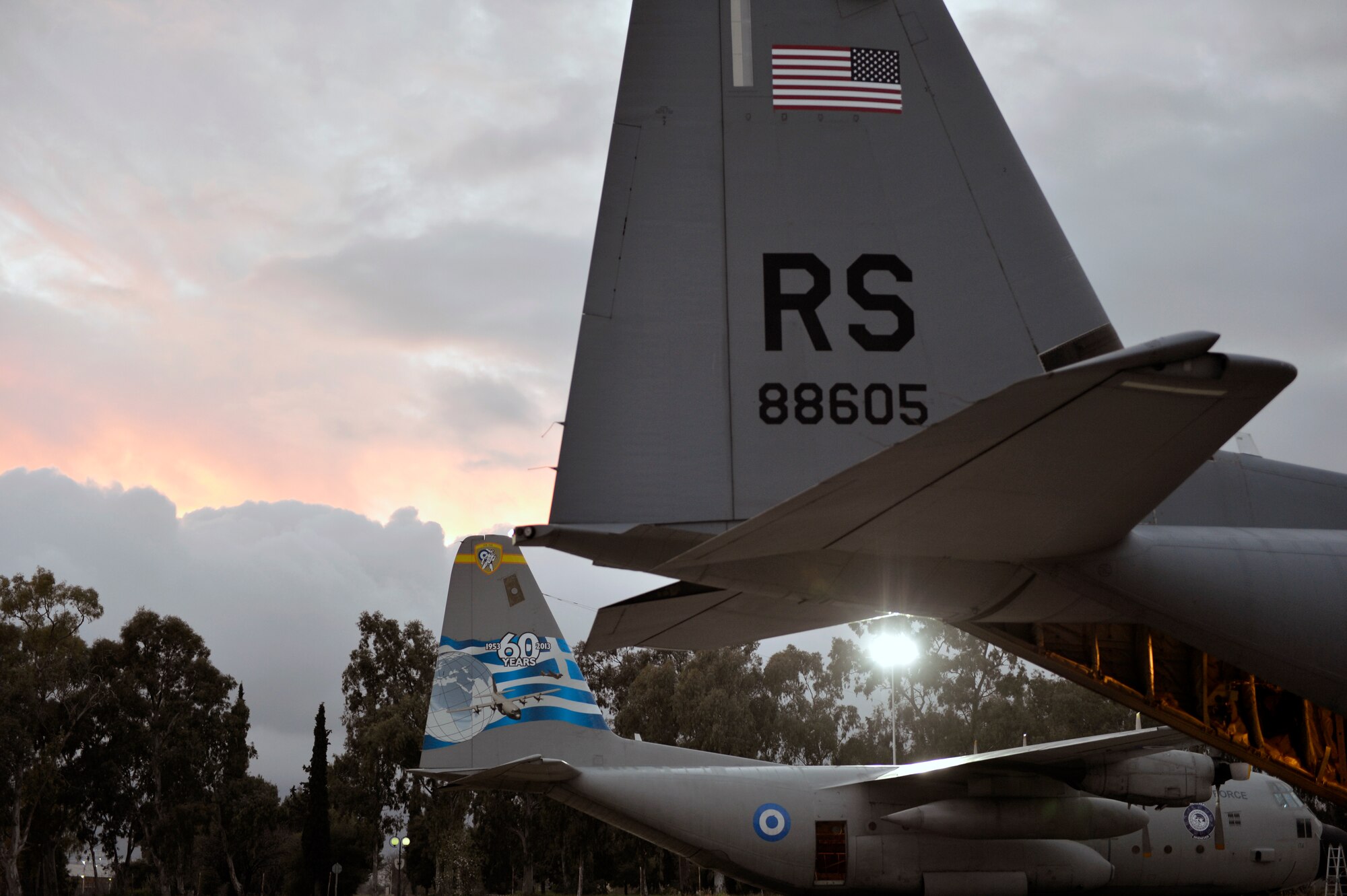 A C-130J Super Hercules sits in a parking spot in front of a Geek C-130H Hercules during Stolen Cerberus, a two-week flying, training deployment designed to incorporate various training methods in order to maintain proficiency during deployed operations and increase interoperability with the Hellenic Air Force, Feb. 2 to 14. The mission provided the U.S. and Hellenic Air Forces a unique opportunity to learn how each service performs airlift operations, improving the joint capabilities of both nations. (U.S. Air Force photo/Staff Sgt. Kris Levasseur)