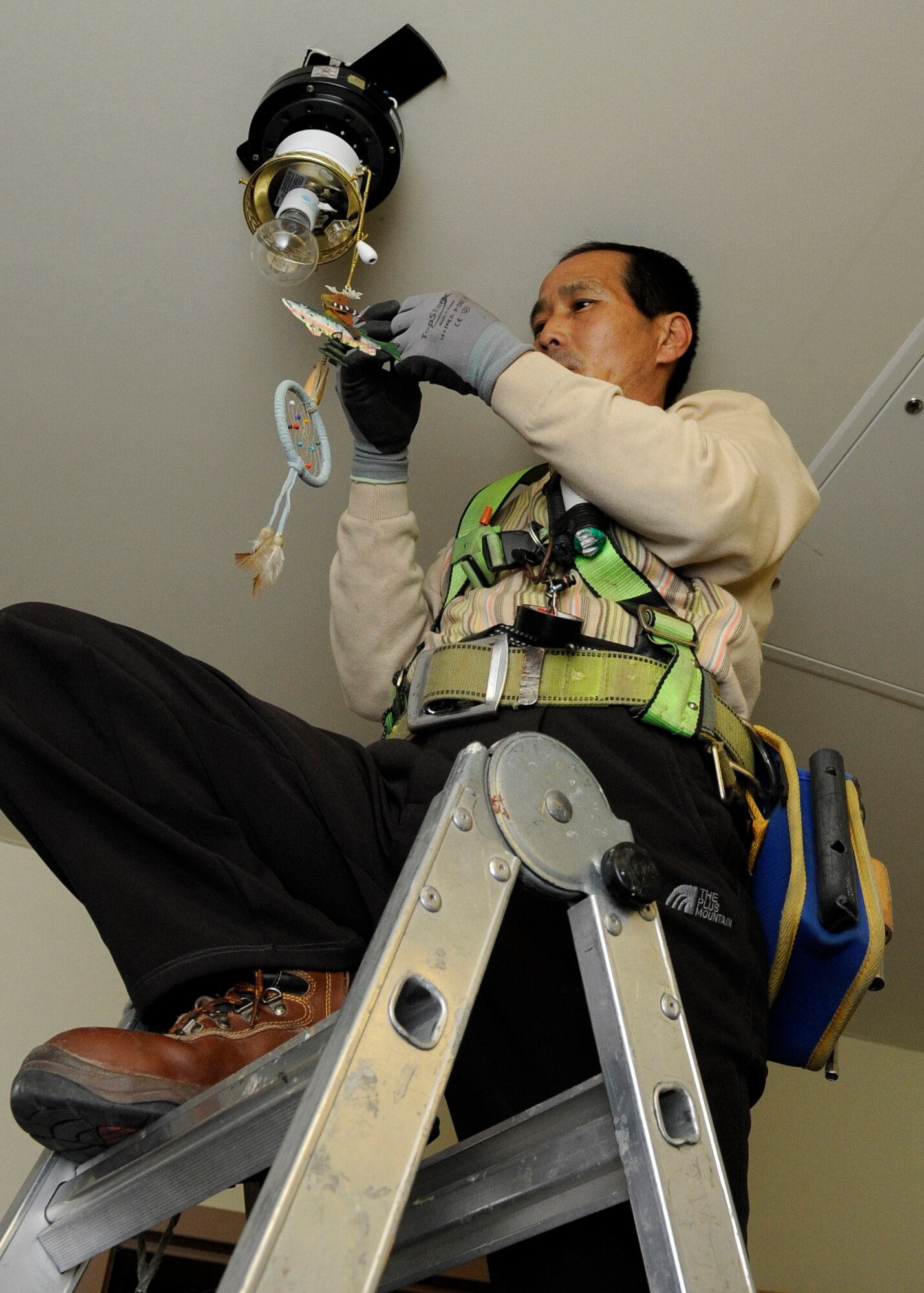 Han Young Sang, Kunsan Air Base contractor, installs the new ‘Keycard Energy Saving System’ on the third floor of building 535 at Kunsan Air Base, Republic of Korea, Feb. 20, 2014. In four and a half years, the system is estimated to save the Air Force a net cost of $539,444. (U.S. Air Force photo by Staff Sgt. Jessica Haas/Released)
