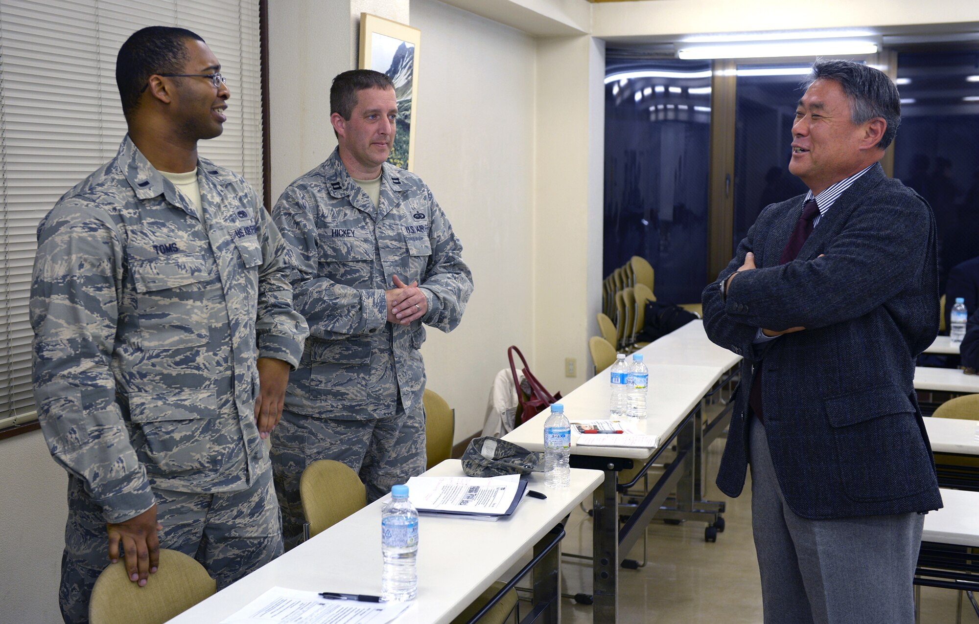 1st Lt. Ralph Toms III, 374th Aircraft Maintenance Squadron assistant aircraft maintenance unit officer in charge, and Capt. Douglas Hickey, 374th Force Support Squadron deputy commander, converse with local civic leaders in Musashimurayama, Japan, Feb. 21, 2014. Toms and Hickey were part of a four-man panel of officers from Yokota Air Base, Japan, who answered questions after briefing the local leaders. (U.S. Air Force photo by Airman 1st Class David Danford/Released)