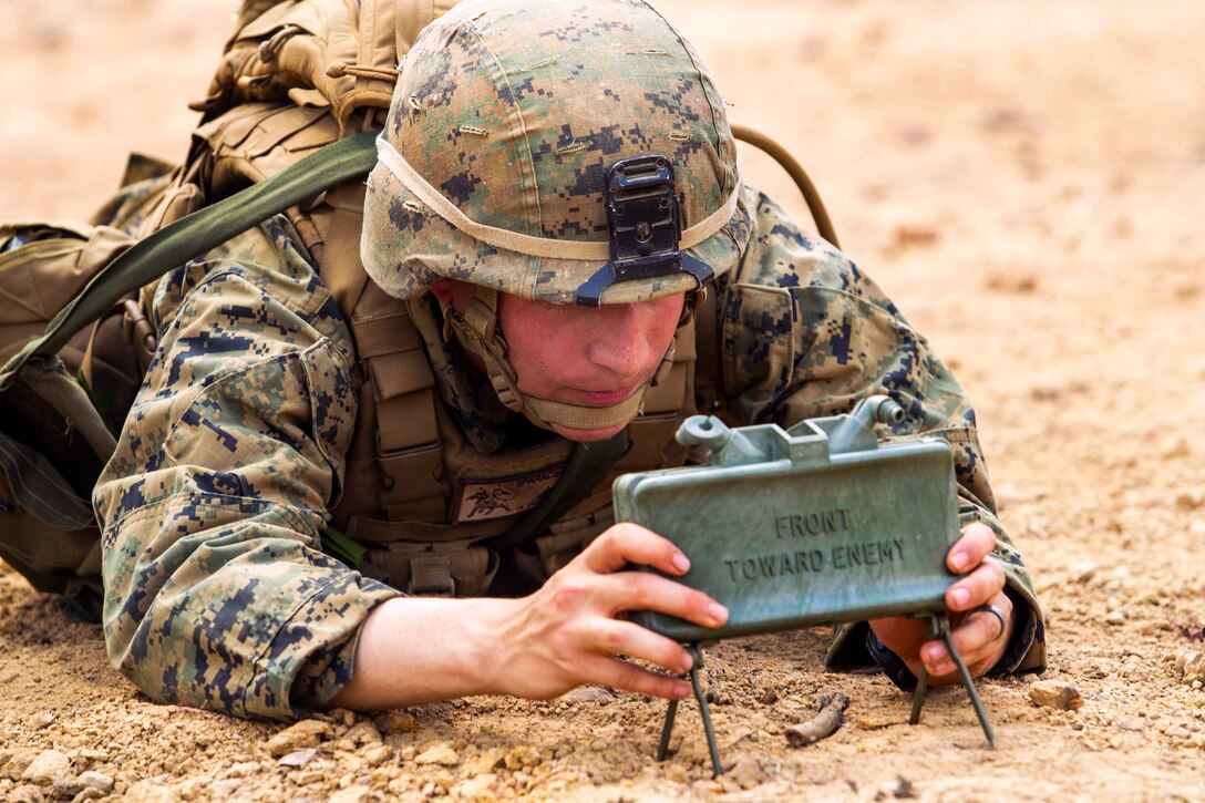U.S. Marine Corps Lance Cpl. Dominique A. Sparacino sets up an M18A1 claymore mine during Exercise Cobra Gold 2014 in Ban Chan Krem, Thailand , Feb. 15, 2014. Sparacino, an infantry assaultman, is assigned to 3rd Battalion, 1st Marine Regiment, 4th Marines, 3rd Marine Division, 3rd Marine Expeditionary Force.
