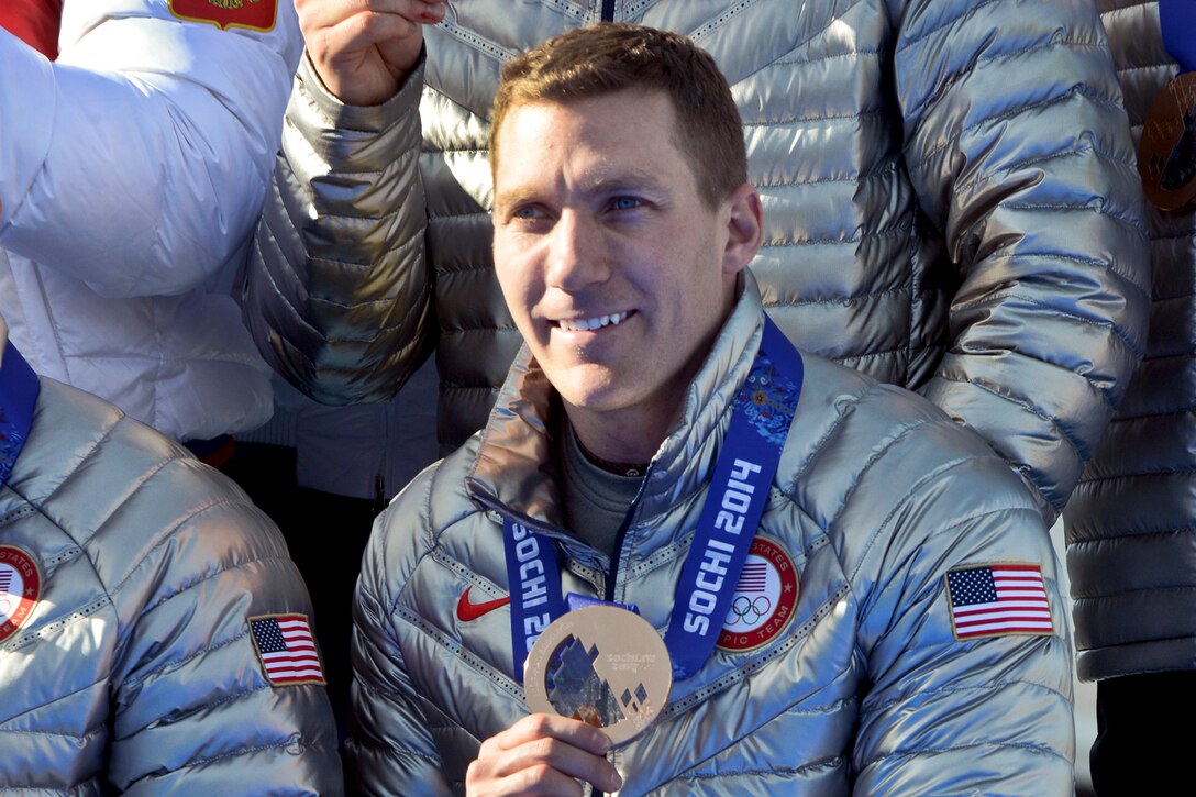 U.S. Army World Class Athlete Program bobsled brakeman Capt. Chris Fogt displays his bronze medal after helping former Team USA bobsled driver Steven Holcomb, Curt Tomasevicz and Steve Langton finish third in the Olympic bobsled event at Sanki Sliding Centre in Krasnaya Polyana, Russia, Feb. 23, 2014. The Russian quartet took the gold.