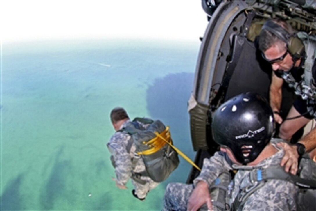 Army Lt. Gen. Charles T. Cleveland, commander of U.S. Army Special Operations Command, jumps from an MH-60 Black Hawk helicopter during an airborne operation over a water drop zone in Biscayne Bay near Homestead, Fla., Feb 21, 2014.