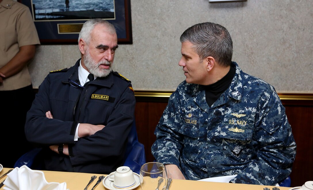 U.S. Navy Capt. George Vassilakis (right), commanding officer of the USS Bataan (LHD 5), speaks with Spanish navy Adm. Santiago Bolibar, admiral of the fleet, aboard the Bataan, at sea, Feb. 22, 2014. The 22nd Marine Expeditionary Unit is deployed to the U.S. 6th Fleet area of responsibility with the Bataan Amphibious Ready Group as a sea-based, expeditionary crisis response force capable of conducting amphibious missions across the full range of military operations. (U.S. Marine Corps photo by Lance Cpl. Caleb McDonald/Released)