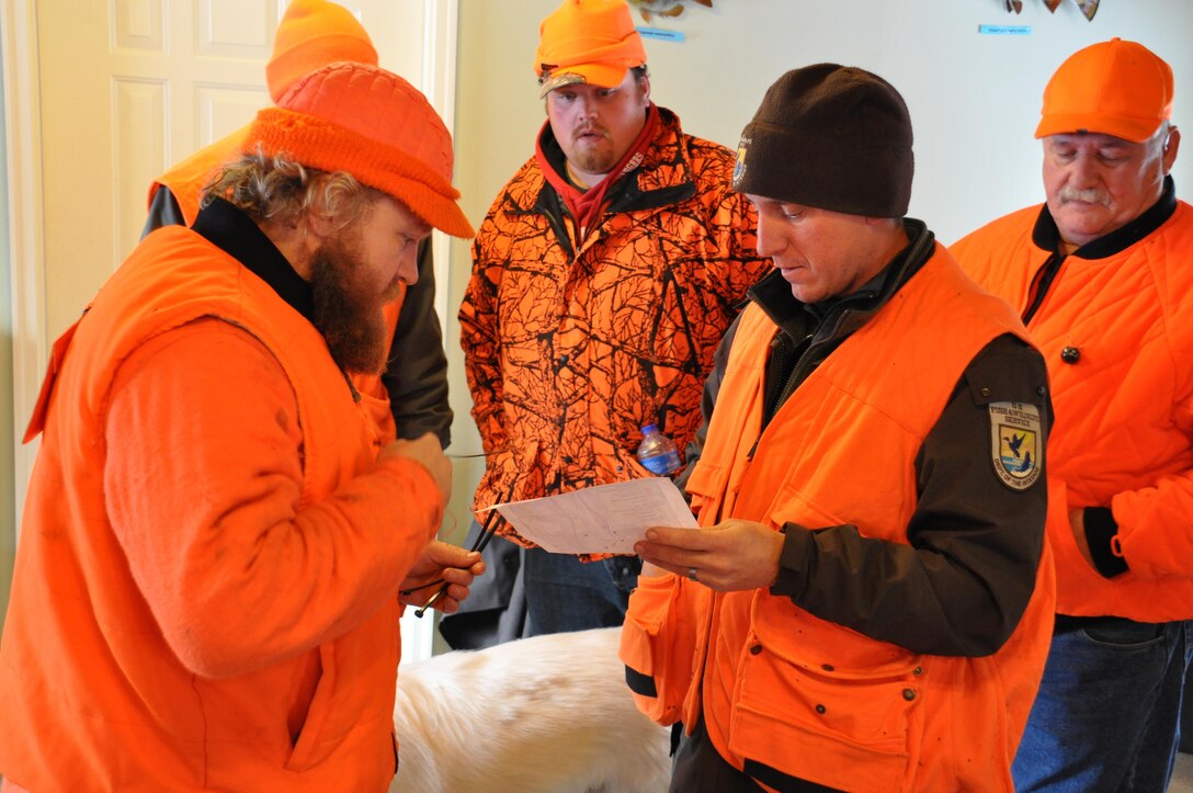 Jon Sobiech, planning, left; Tom Drinken, Wounded Warrior
participant; and Scott Pariseau, a U.S. Fish and Wildlife Service
volunteer, review a map of the Eau Galle Recreation Area prior to
heading out to the deer stands at the park, near Spring Valley, Wis.,
Dec. 14. This was the second Wounded Warrior hunt at the park.